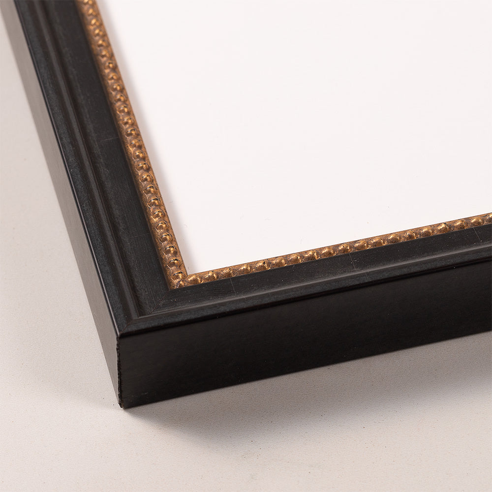 Black picture frame with a gold beaded inner edge for displaying art or photos.