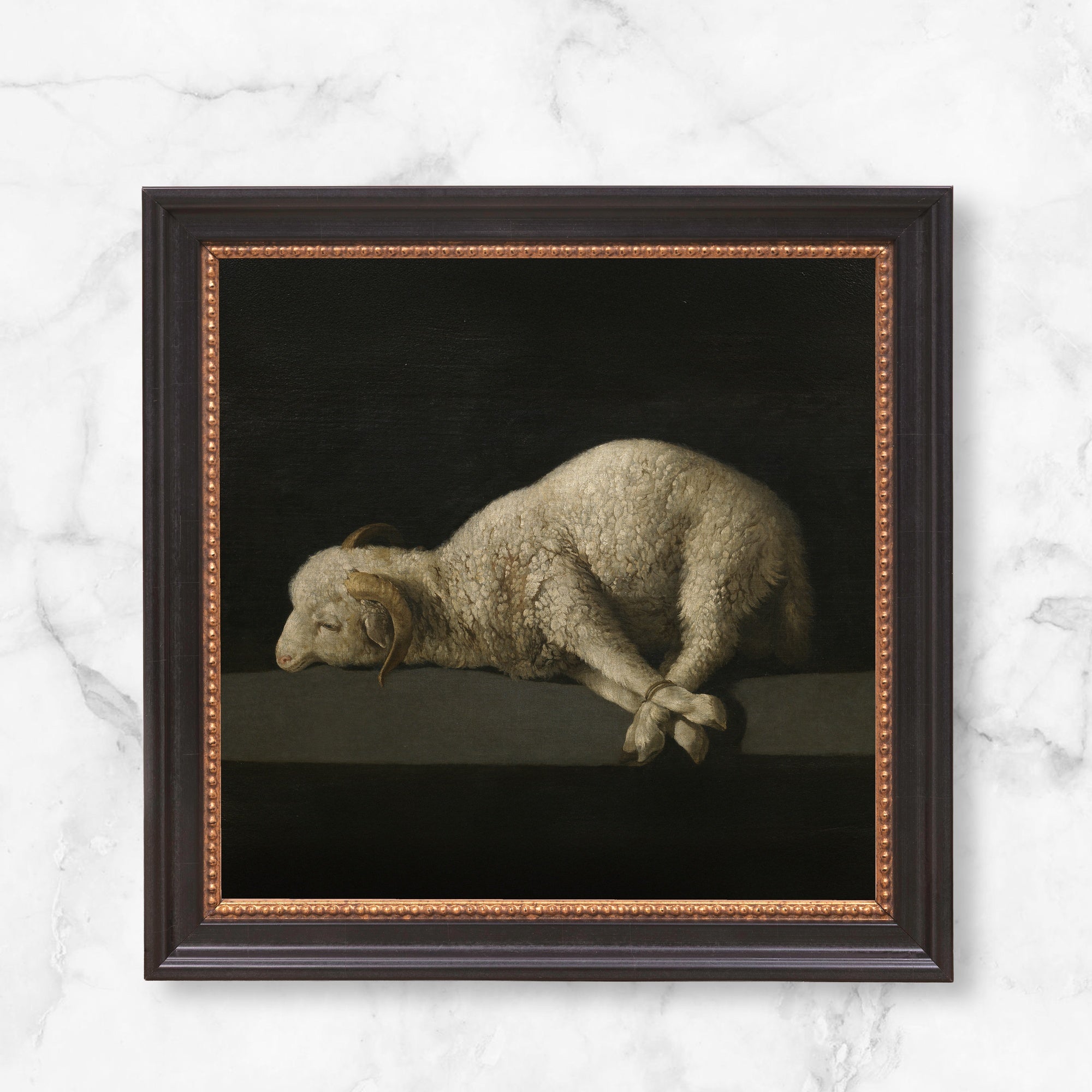 Framed "Agnus Dei" print, vintage style. The painting is of a sheep with dark background, in a dark frame with golden detail.