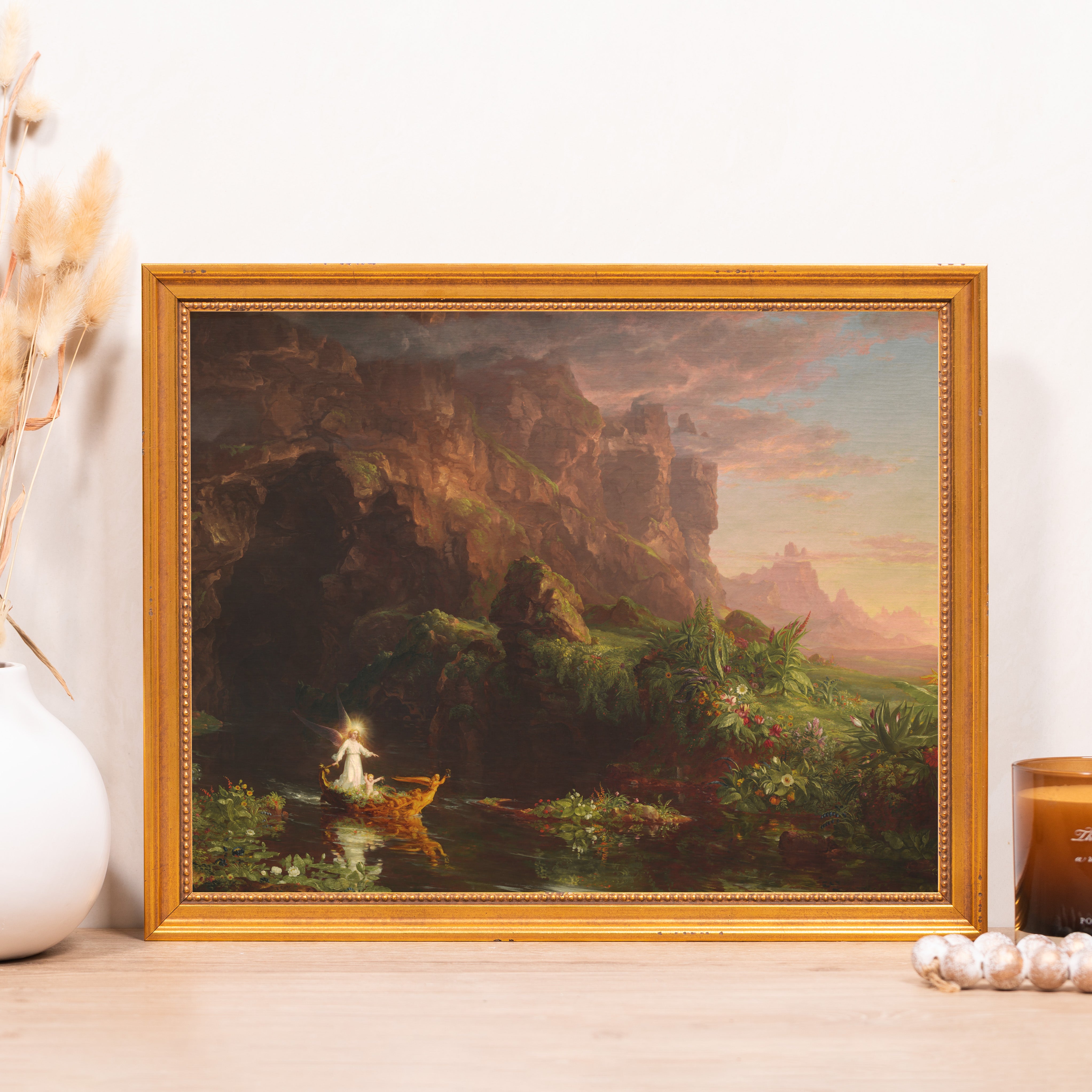 Framed wall art: Landscape painting in gilt wood frame depicting mountains, river, and an angel on a boat.