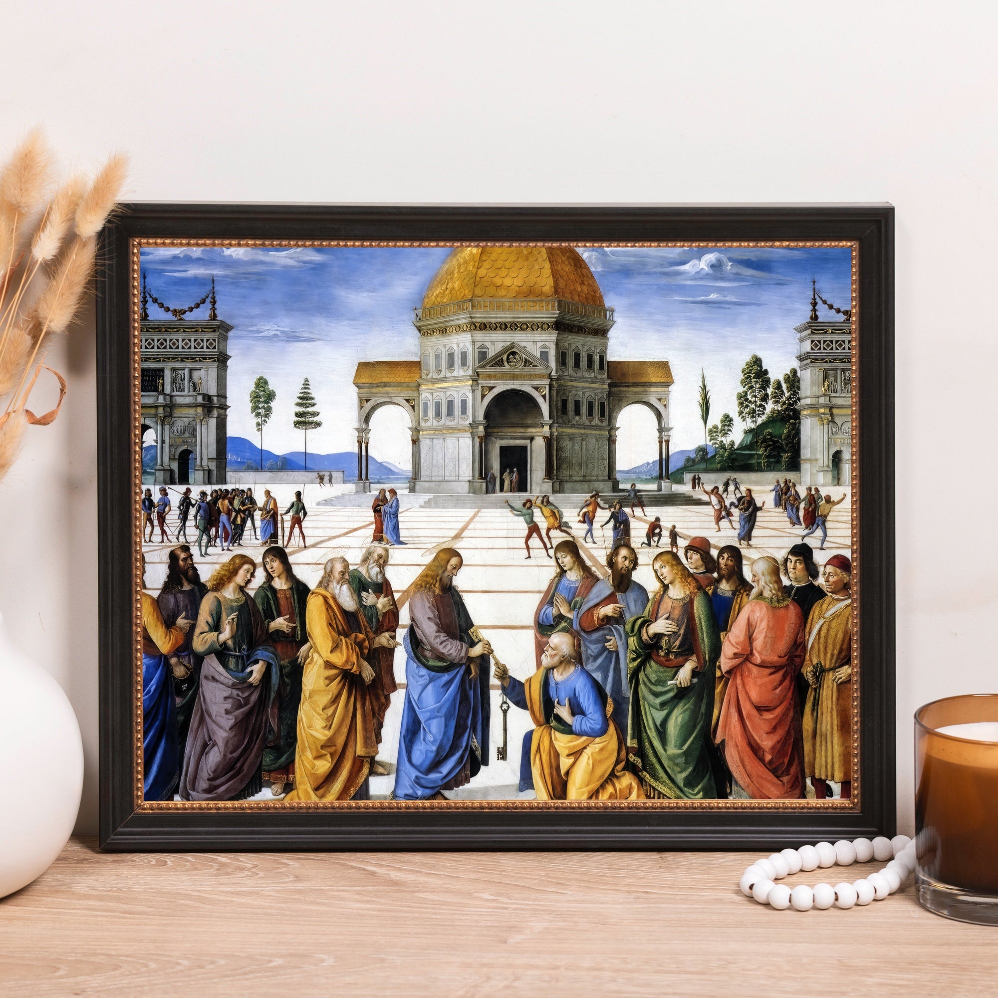 Framed artwork shows biblical scene of Peter receiving the keys to Heaven, colorful figures, dark frame.