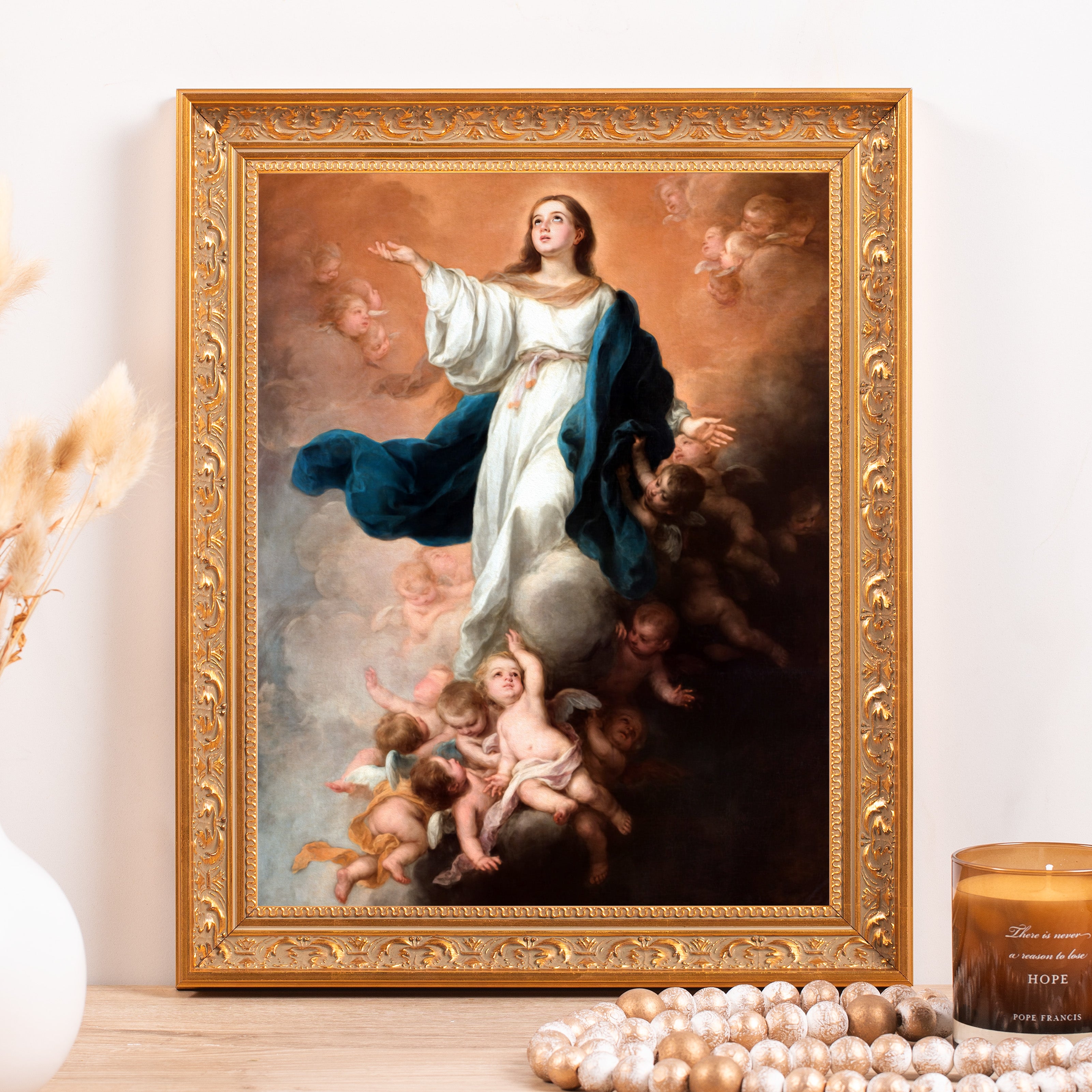 Framed painting of a woman surrounded by angels with a gold frame.