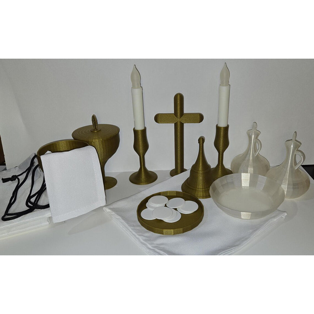 Communion set: gold and white cross, candles, chalice, linens, host wafers, and cruets for religious practice.