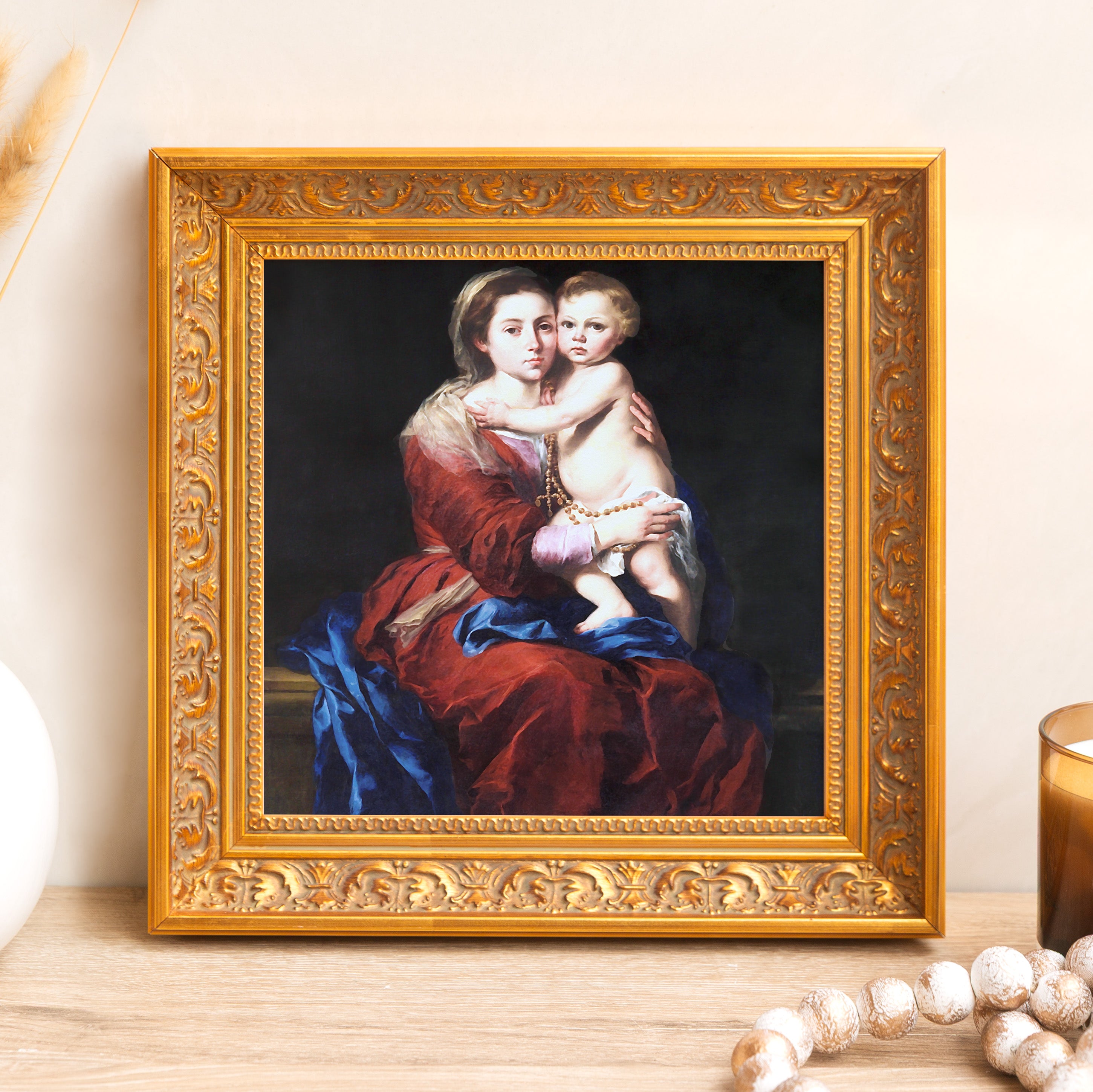 Framed print depicts Madonna and Child in ornate gold frame; wall decor.