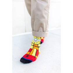 Man's colorful socks featuring a stained-glass dove design in red, yellow, and orange with black toes.