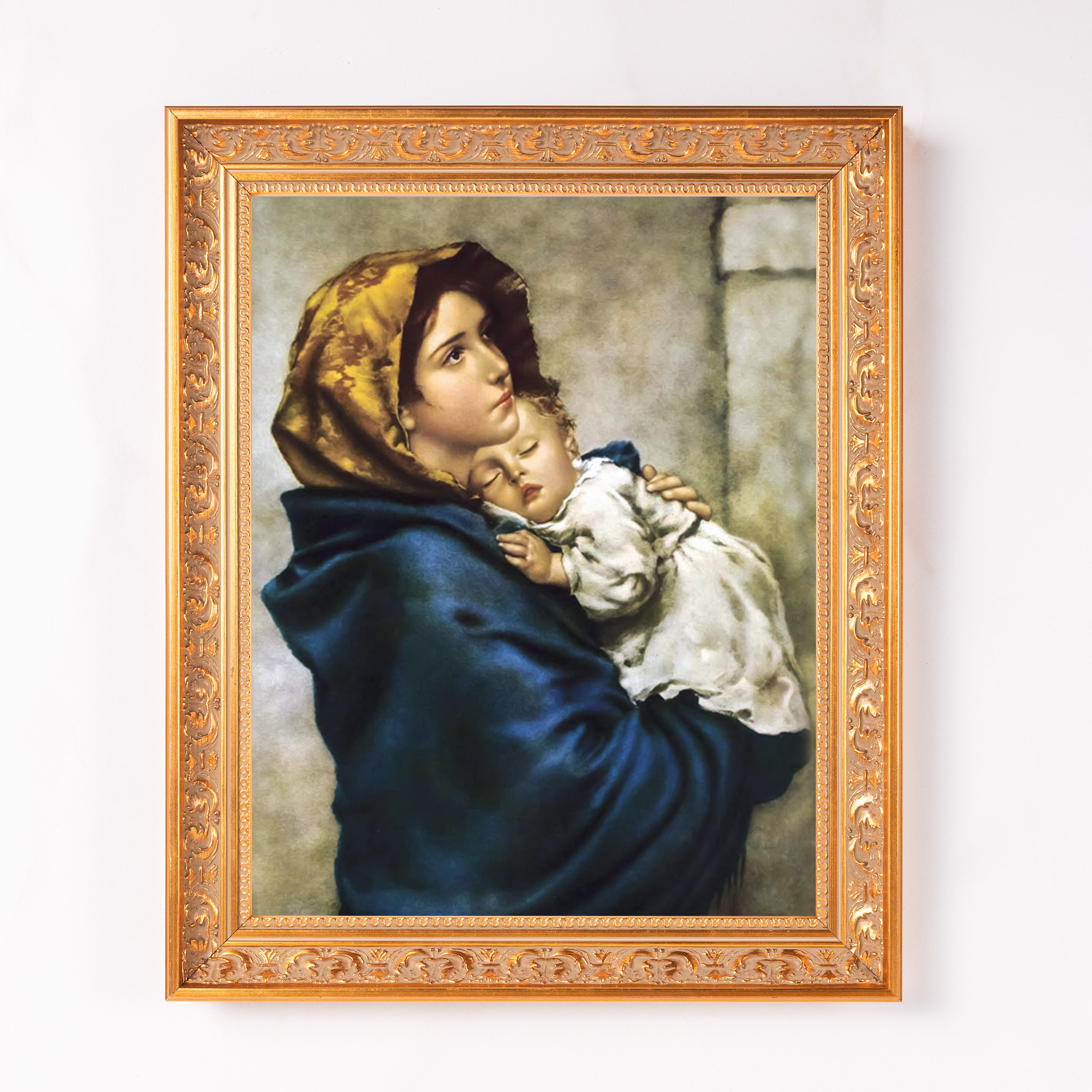 Framed painting of Mary holding baby Jesus in a golden ornate frame.