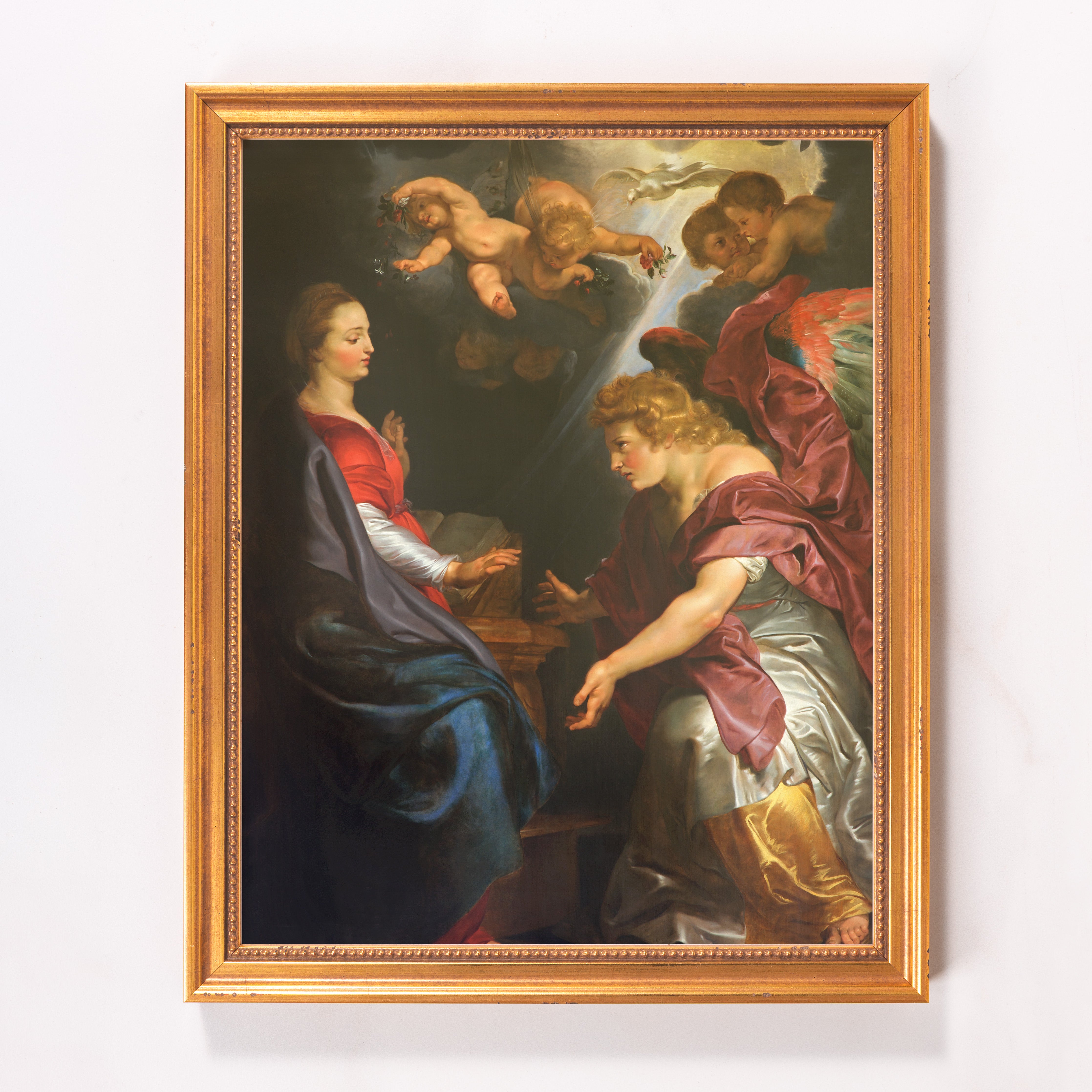 Framed Annunciation painting. Angels, draped figures in golds, reds, blues on canvas in ornate gold frame.