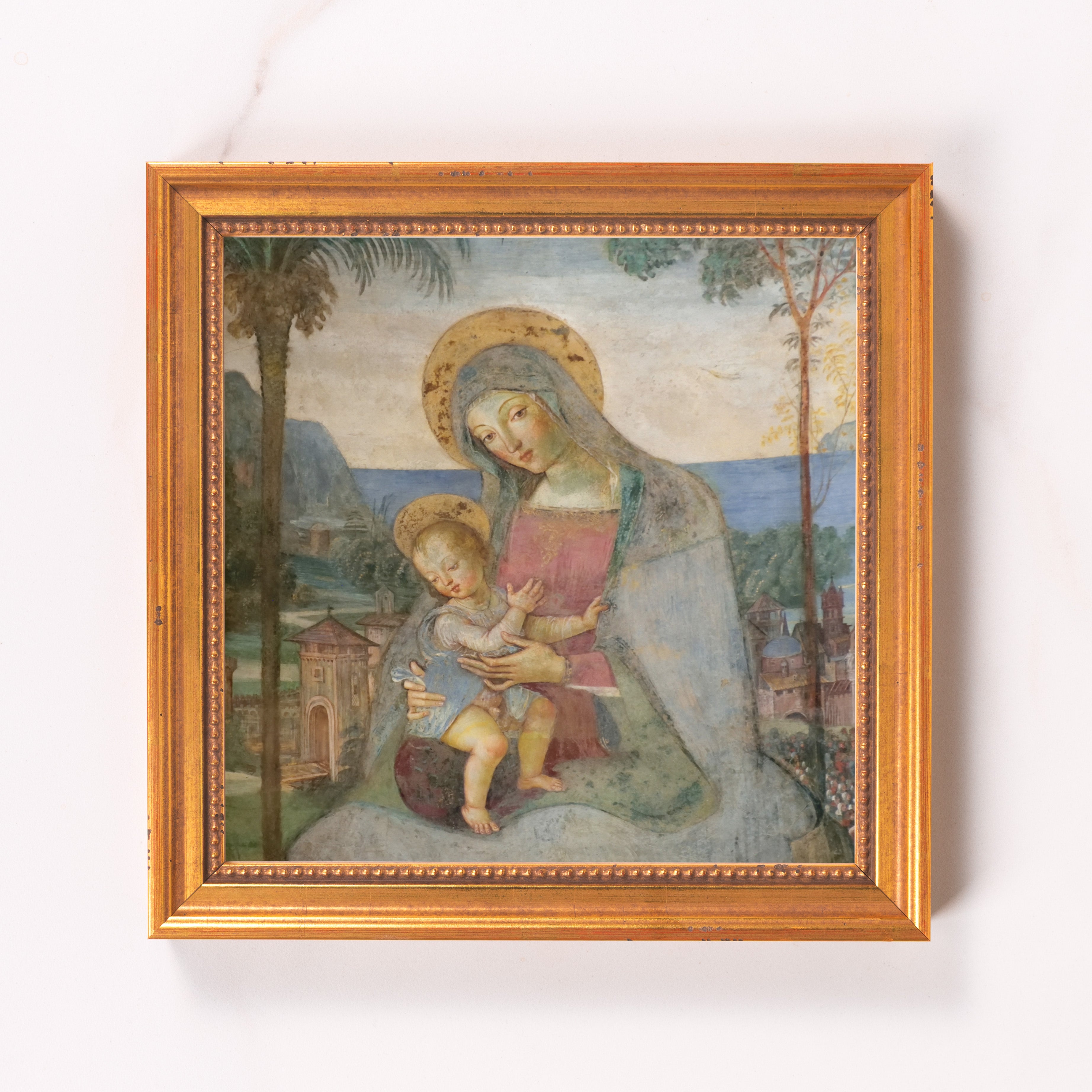 Framed Madonna and child art print, antique style, with golden frame.
