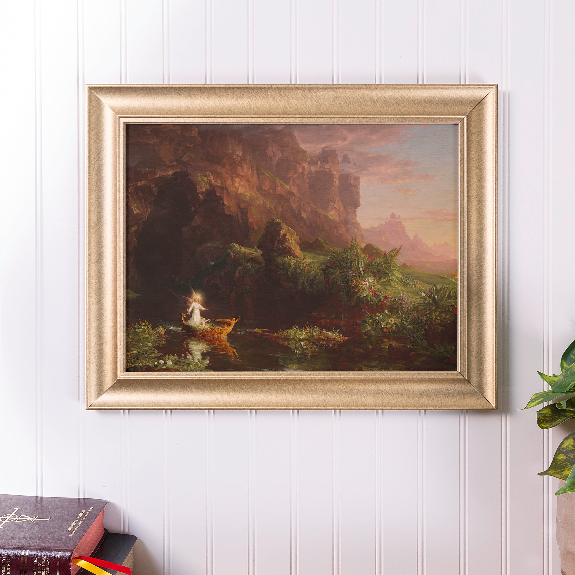 Framed art print. Golden frame; painting shows a landscape with a glowing angel and child in a boat.