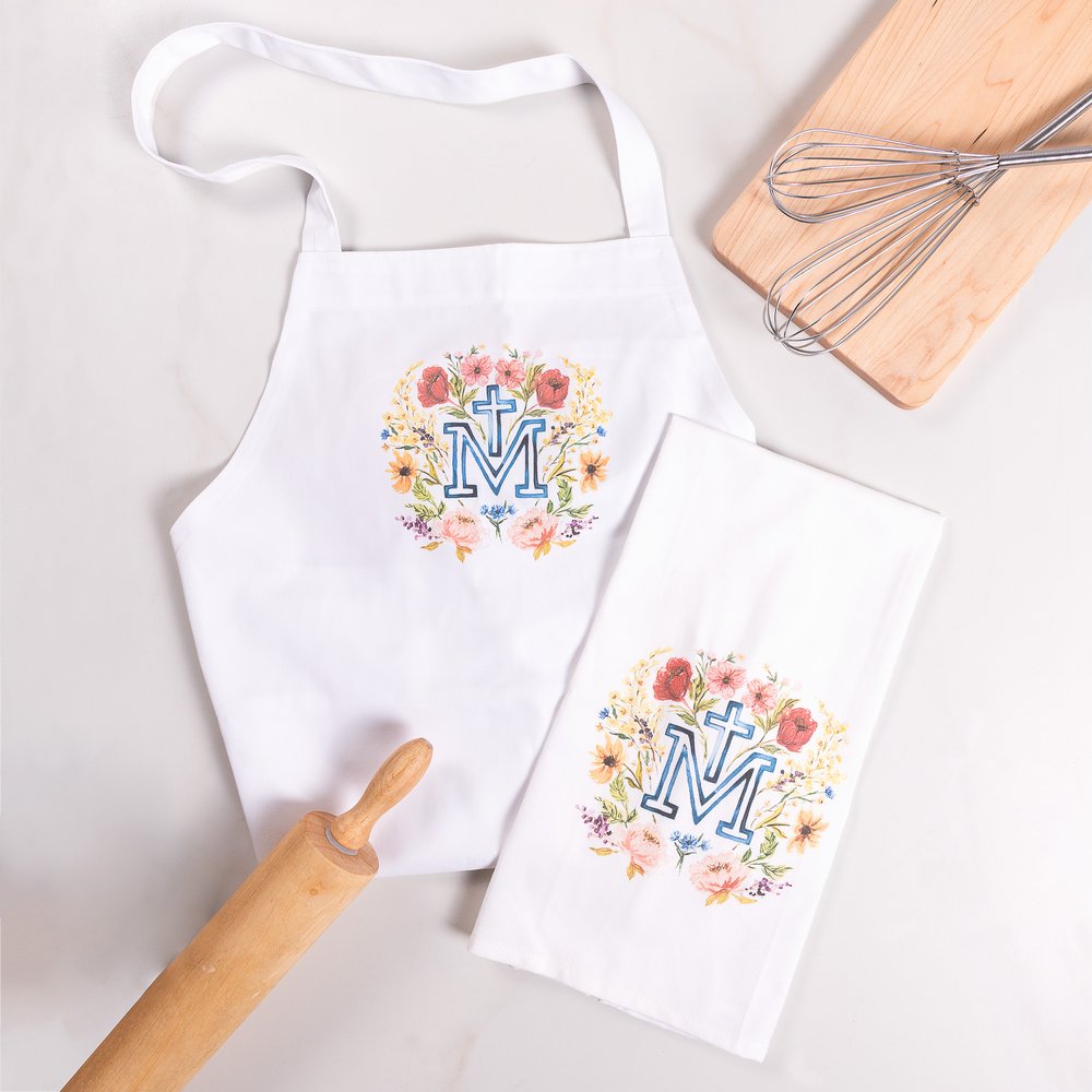 White apron and towel with a floral M monogram print for cooking and cleaning.