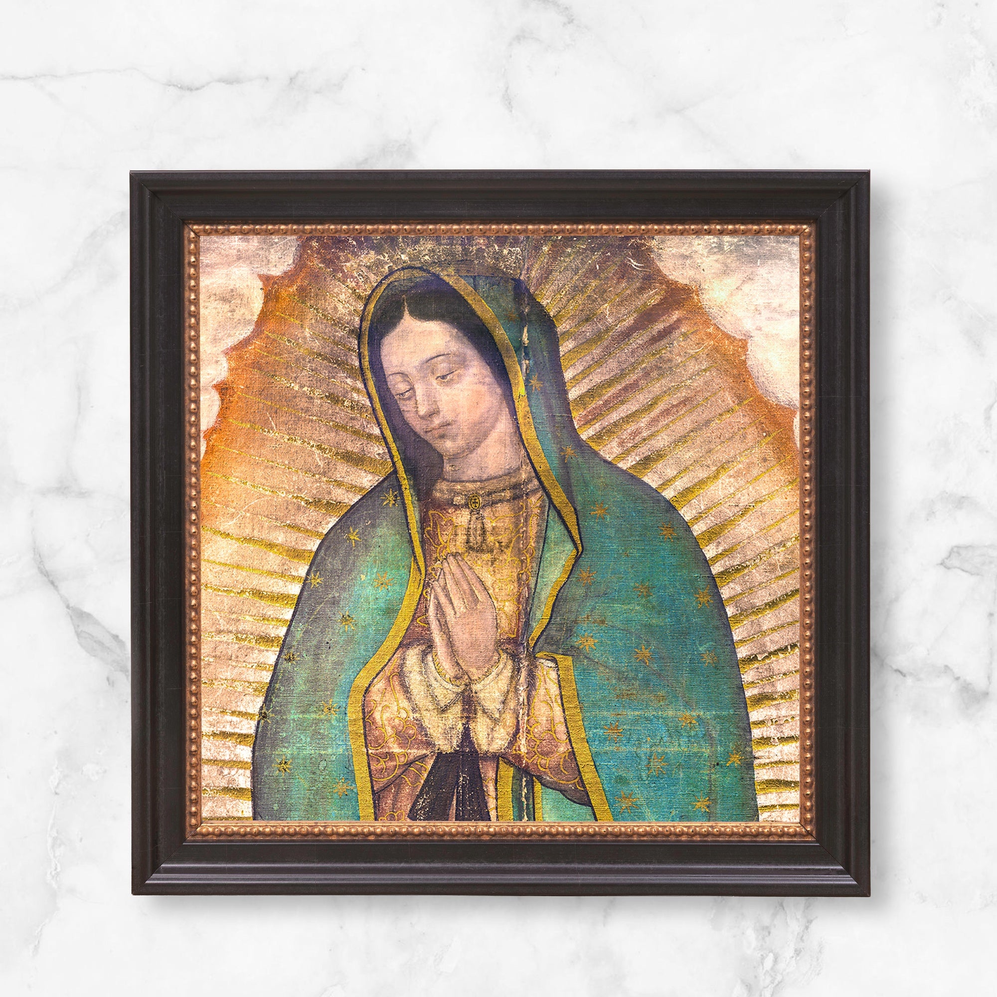 Framed Our Lady of Guadalupe print; canvas art with dark frame, golden aura, and turquoise cloak with stars.