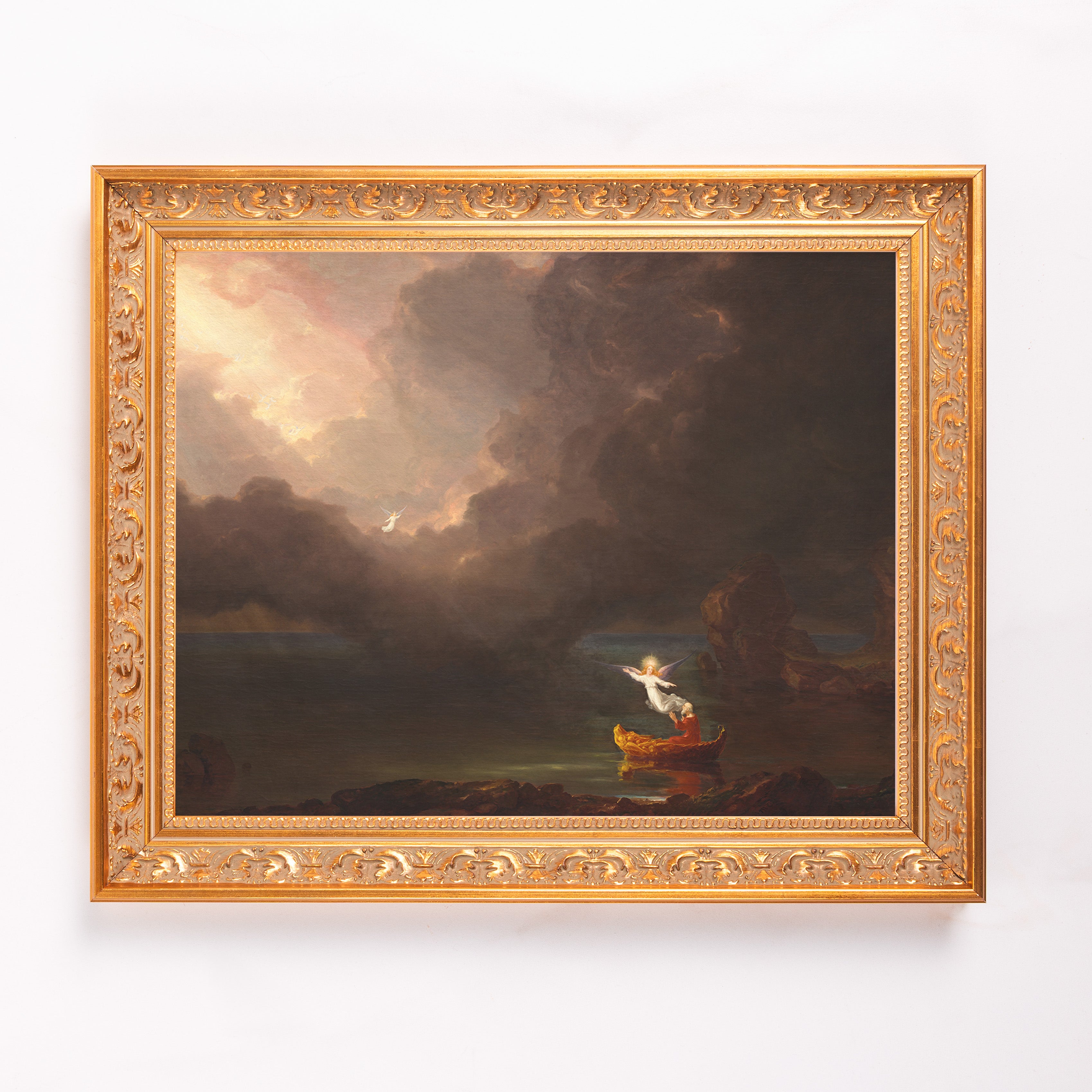 Framed canvas print shows an angel guiding a boat with dramatic light and clouds; has a gold ornate frame.