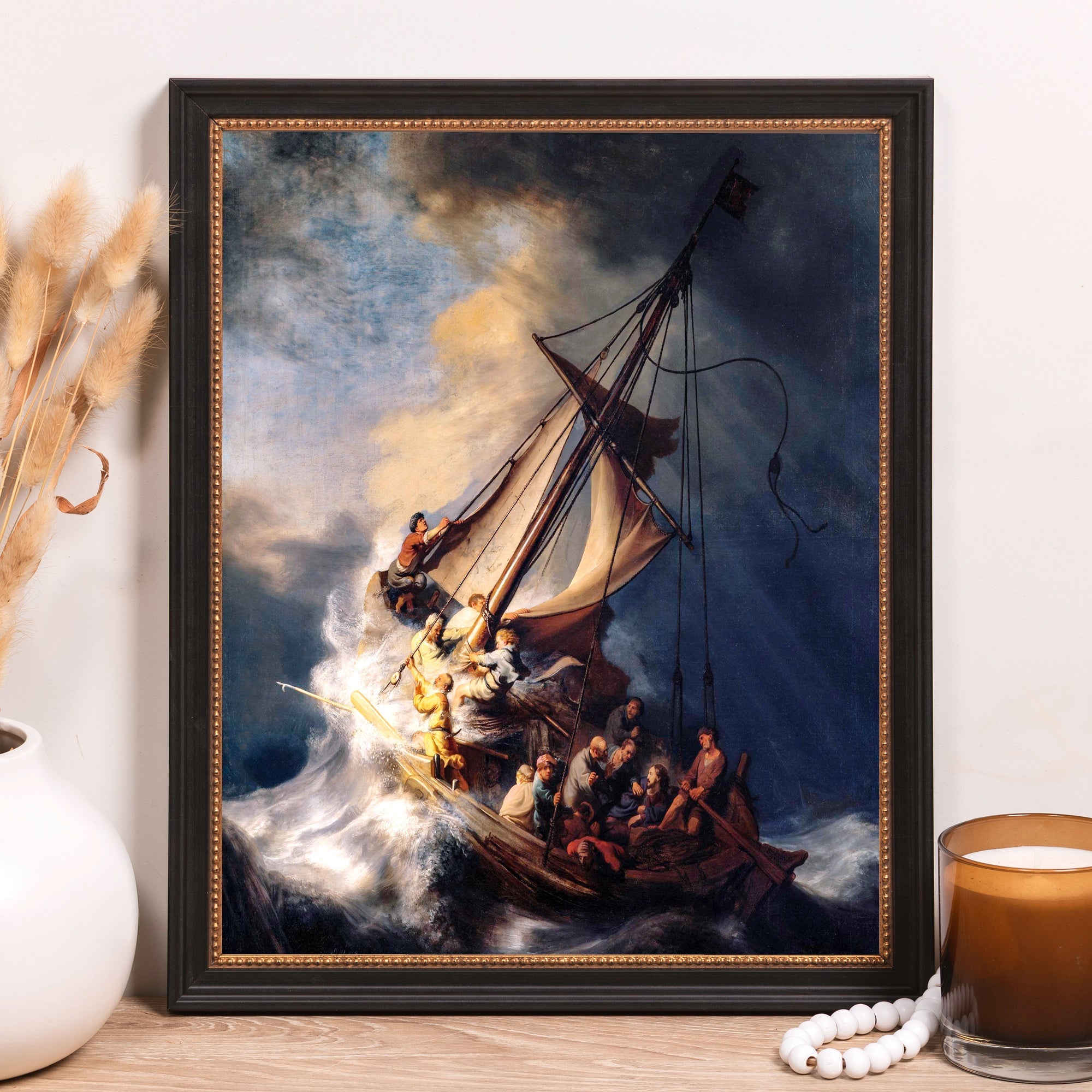 Framed painting of storm at sea, Rembrandt style, on canvas with black frame.