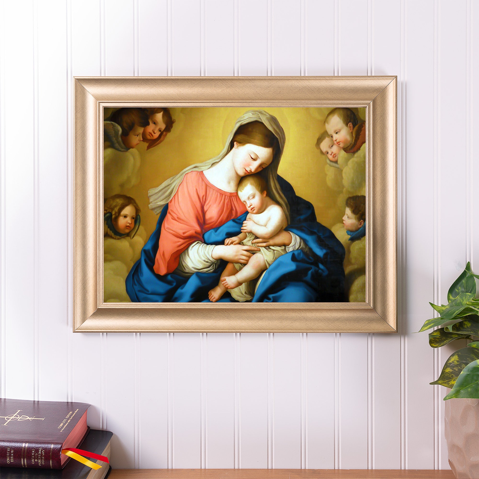 Framed painting of Mary holding the infant Jesus, surrounded by angels; gold frame.