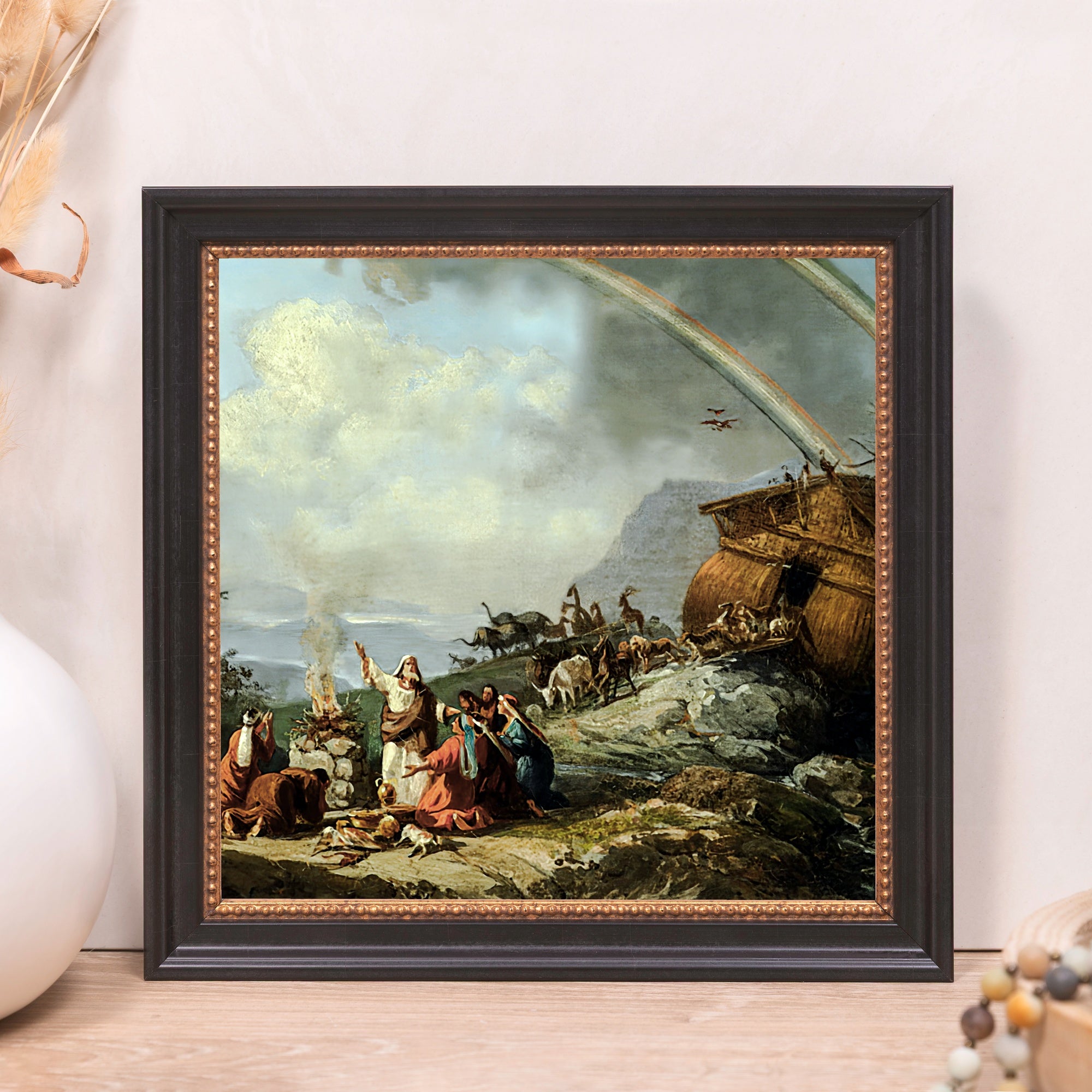 Framed print of Noah's Ark, depicting a rainbow, animals, and people; black frame with gold accents.