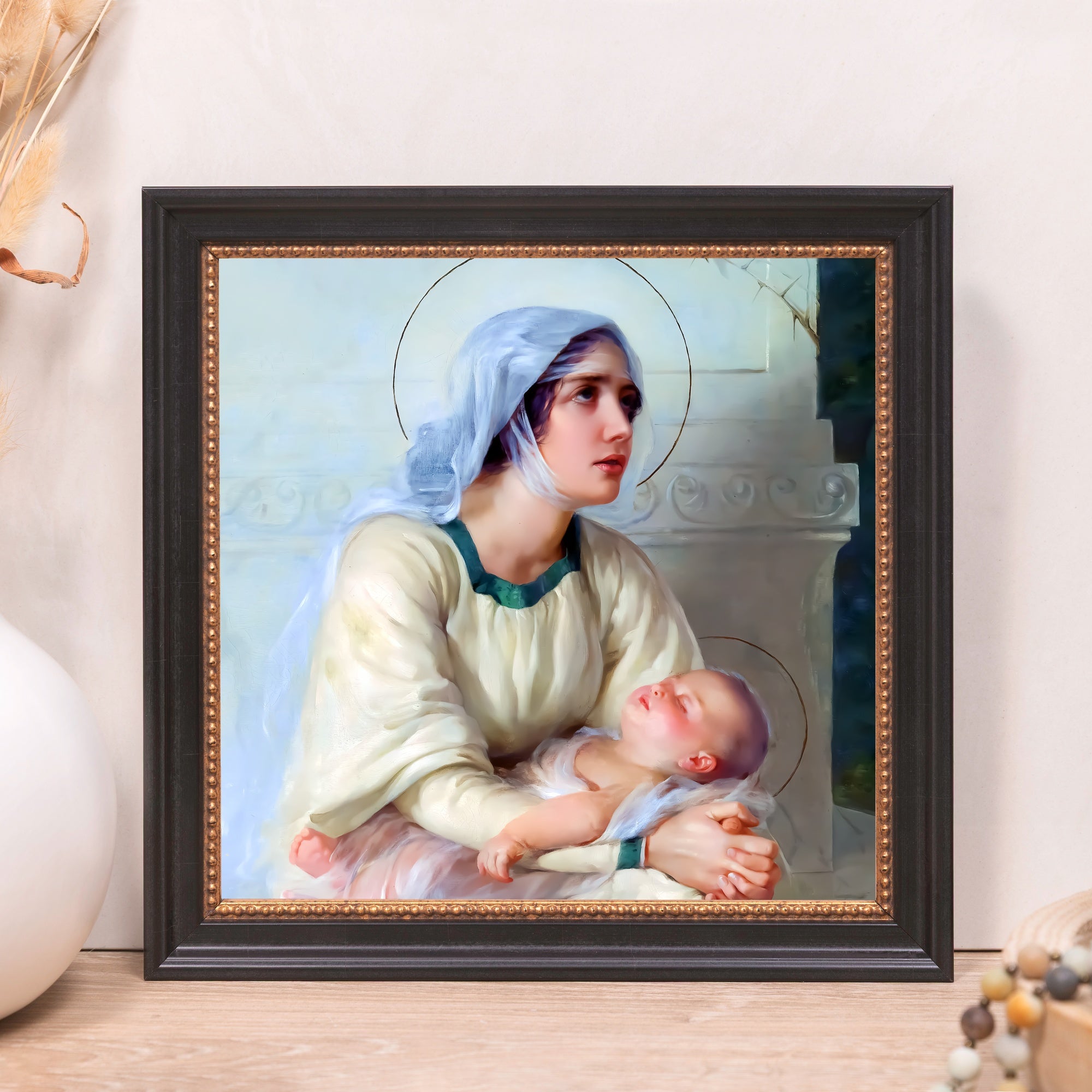 Framed "Madonna and Child" print features Mary holding Jesus, black/gold frame, traditional style.