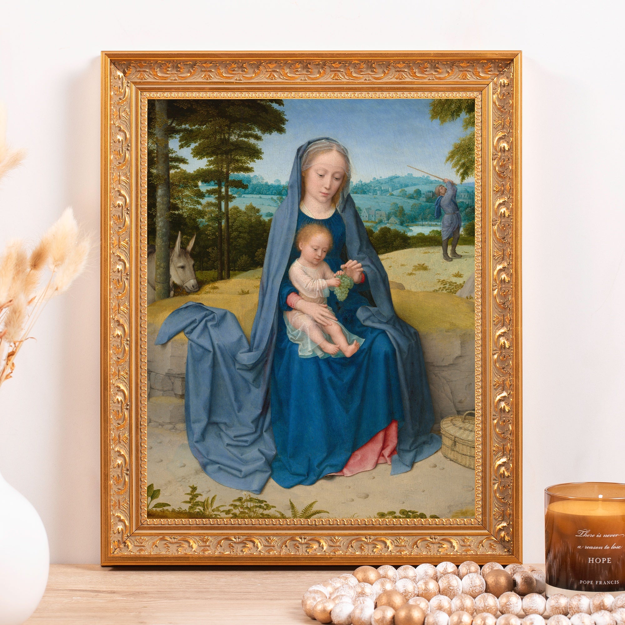 Framed painting of Madonna and child in blue robes, ornate gold frame.