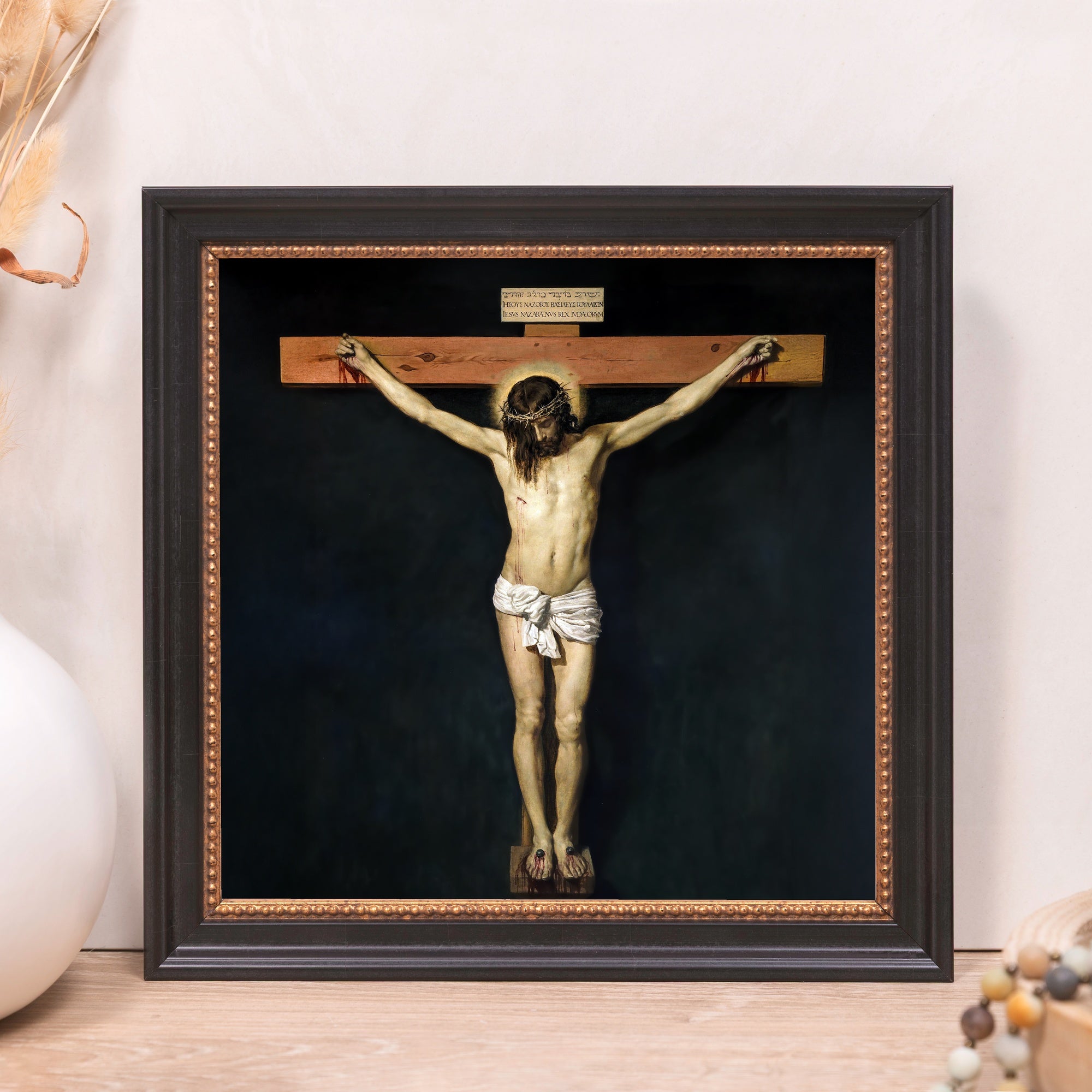 Framed Crucifix art print; dark wood frame and an image of Jesus Christ on the cross on black background.