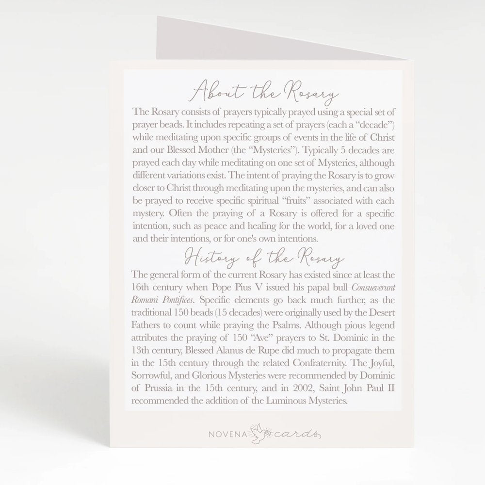 Informational paper card explains the rosary's use and history, off-white with gray text and a simple decorative logo at the bottom.