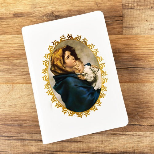White notebook with religious image of mother and child on the cover surrounded by gold foil trim.