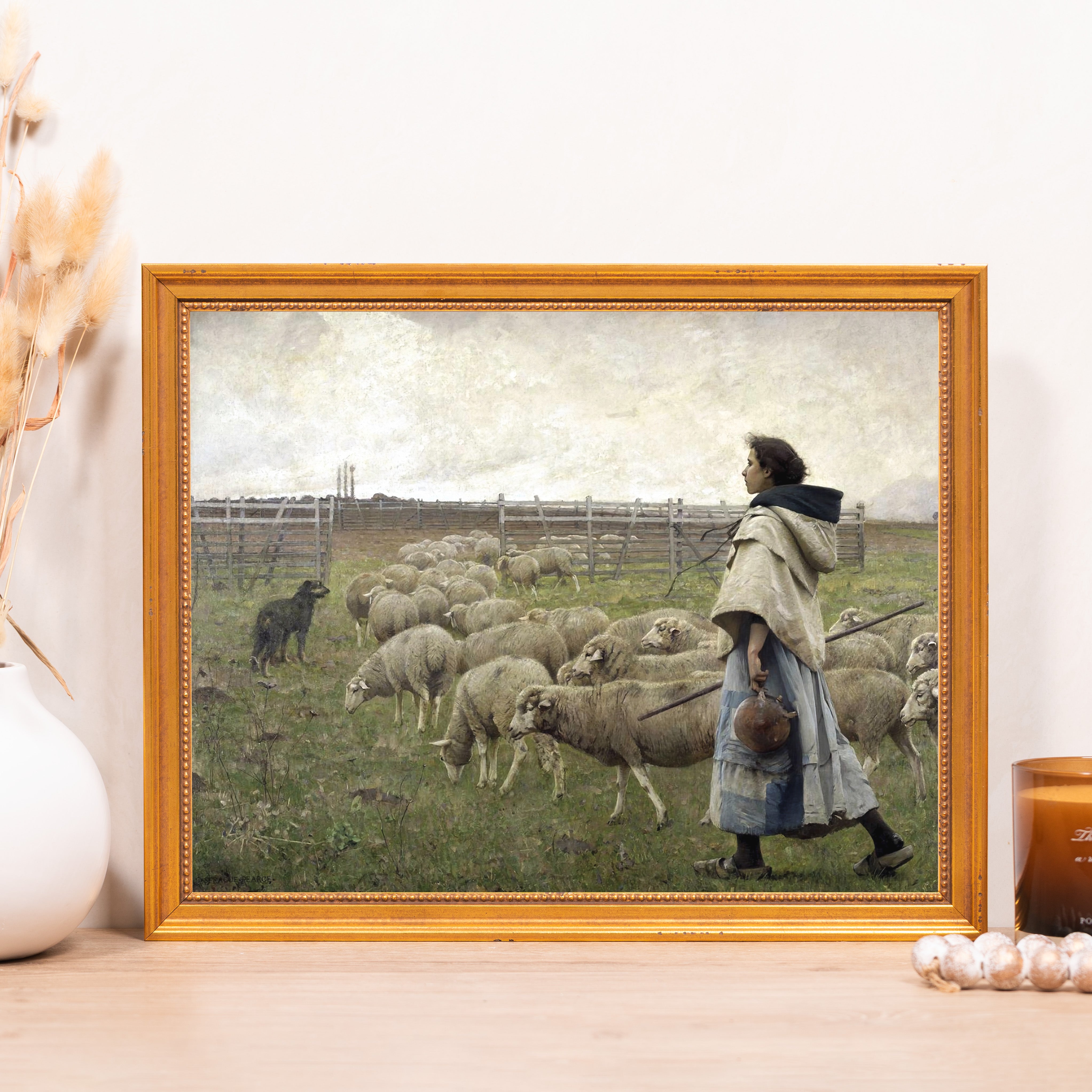 Framed pastoral print of shepherdess with flock, golden wood frame.