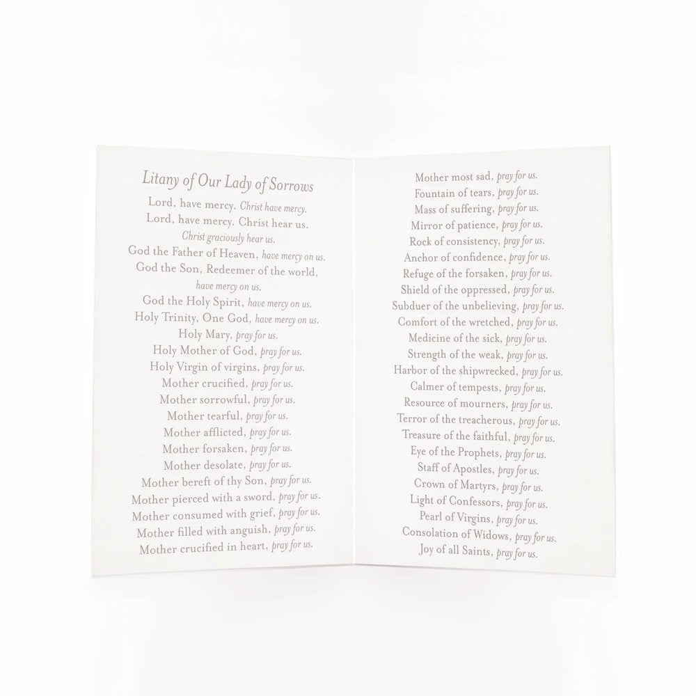 Open, White paper booklet with the Litany of Our Lady of Sorrows printed in gray serif font.