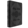 Black, Leather, Holy Bible with decorative engravings and "Katie Anne" embossed on the cover.