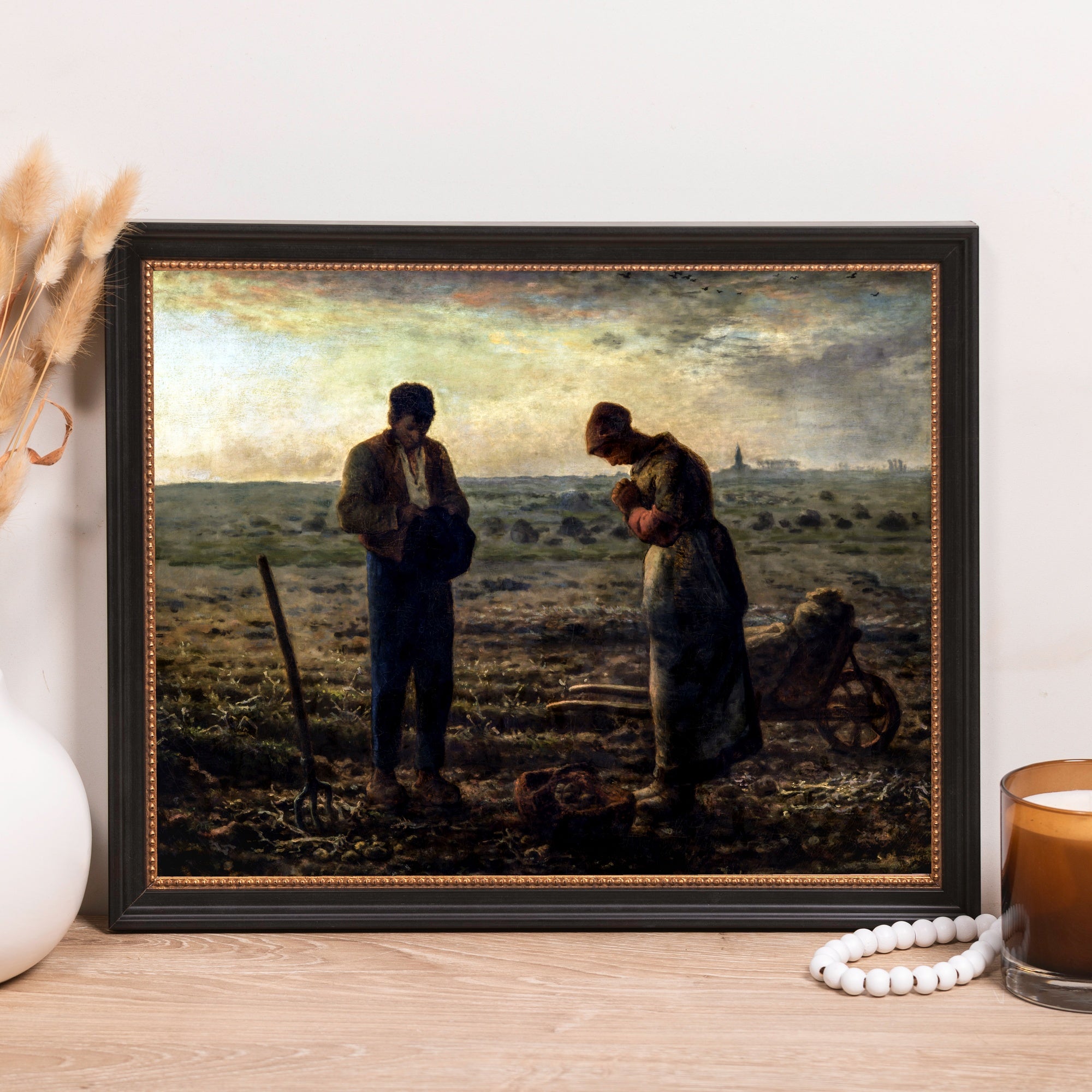 Framed "The Angelus" oil painting reproduction showing two peasants praying in a field at sunset.