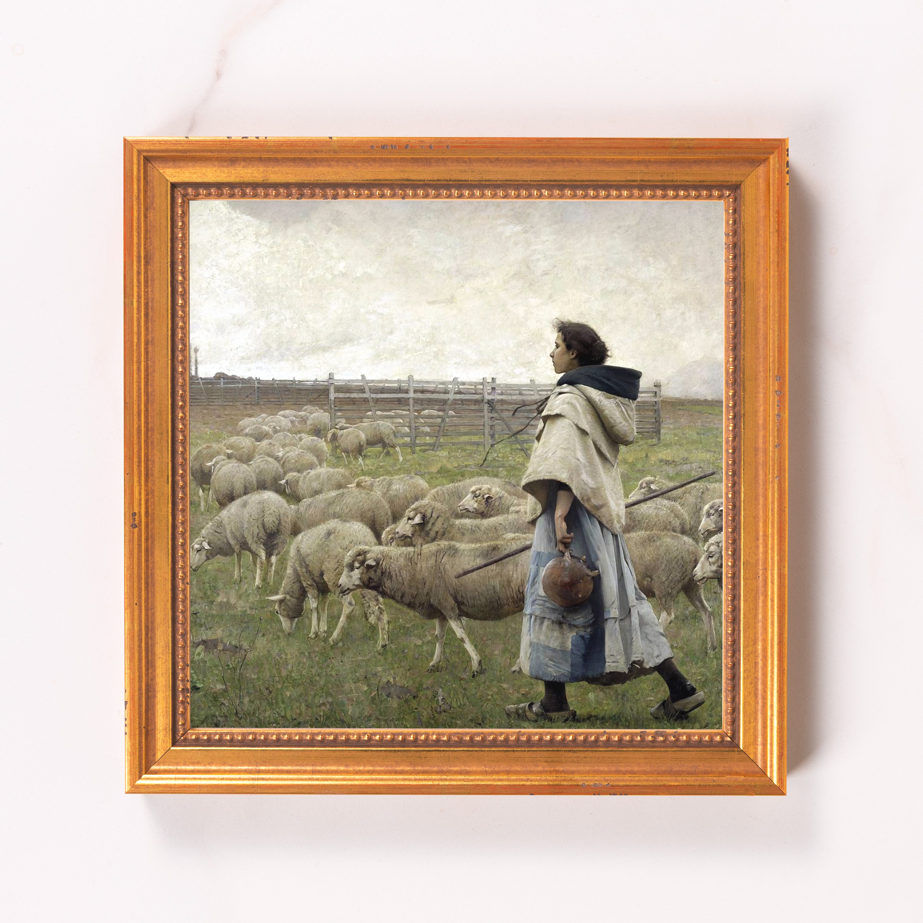 Framed canvas print of a woman shepherding sheep, oil painting style in gold frame.