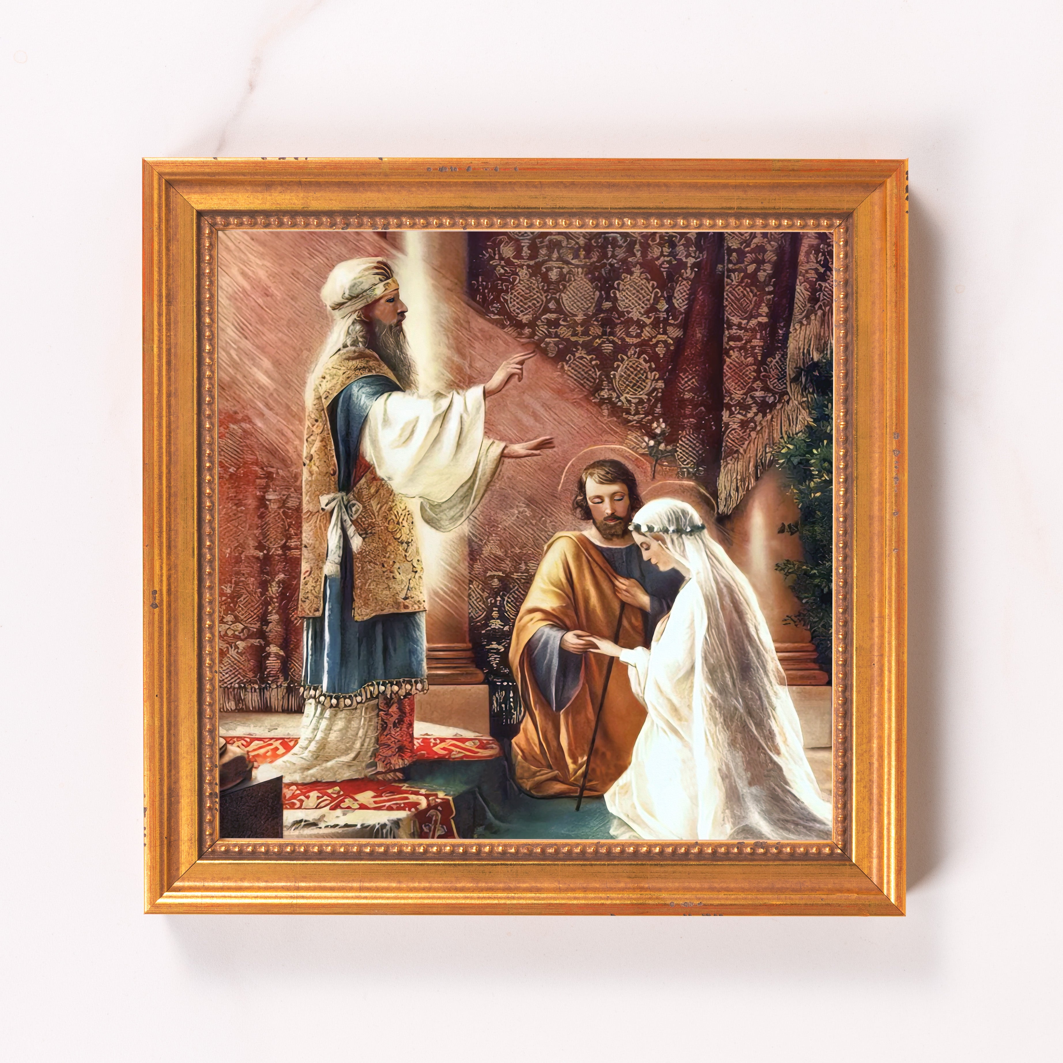 Framed art print of marriage scene in warm tones with gold frame.