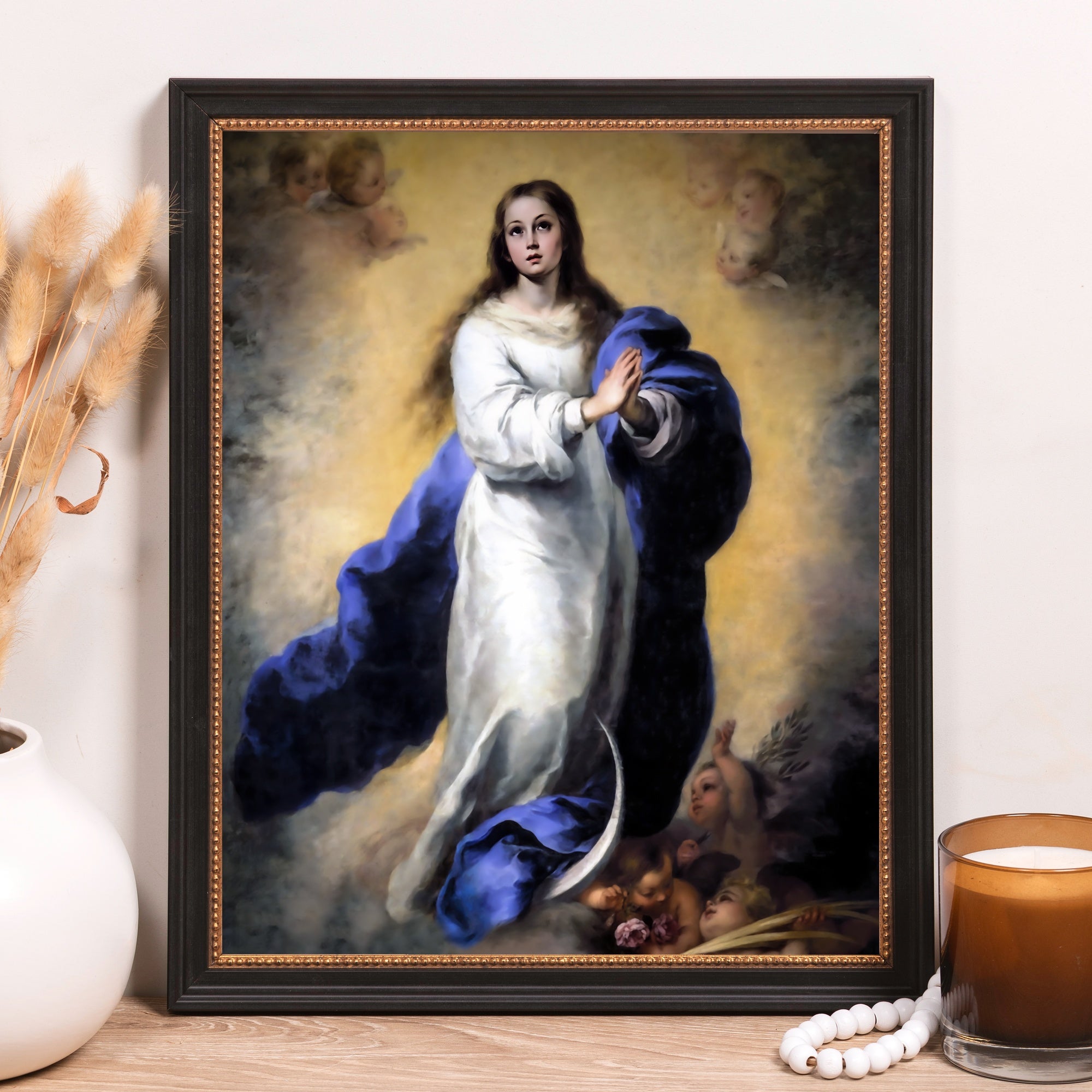 Framed Virgin Mary art print in black frame with blue cloak, classical style.