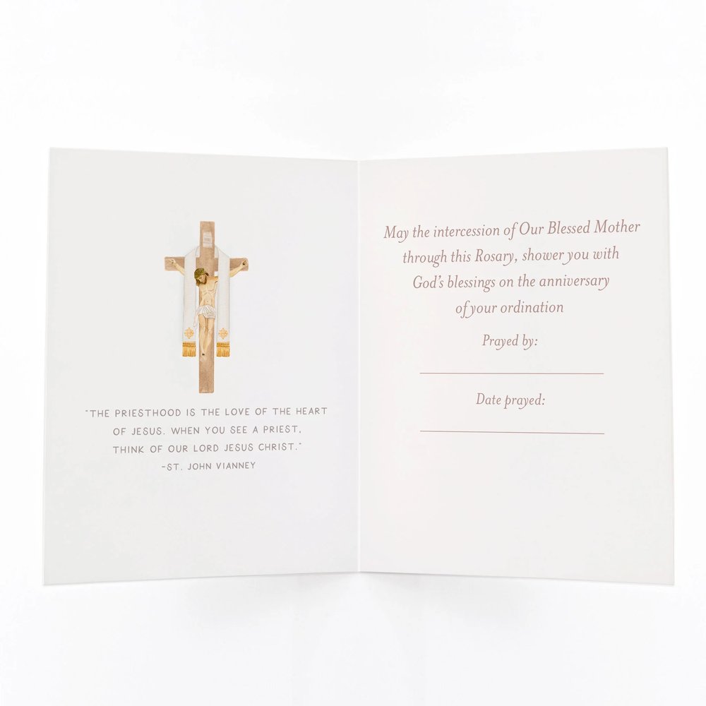 Open greeting card for priest ordination anniversary, featuring cross graphic and message of blessing.