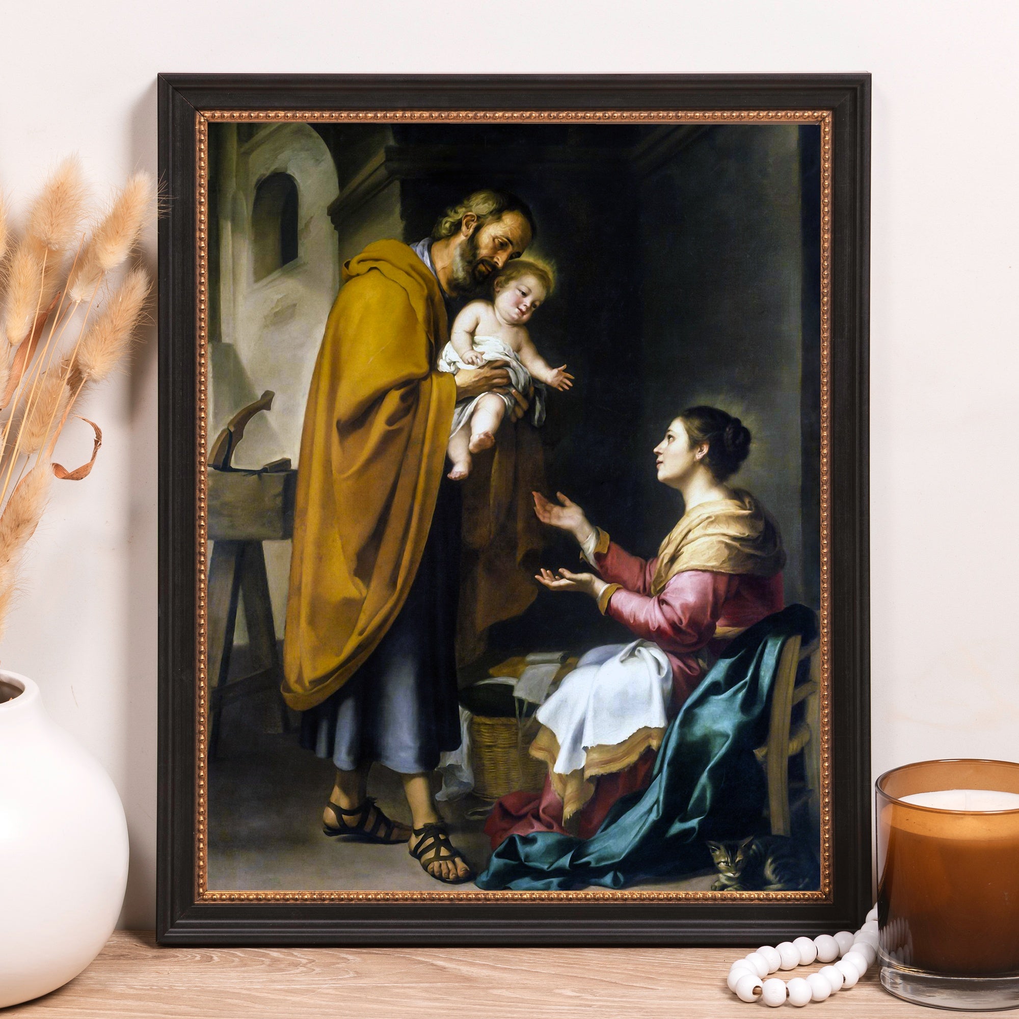 Framed painting of the Holy Family in an oil-painting style with rich colors and dark accents.