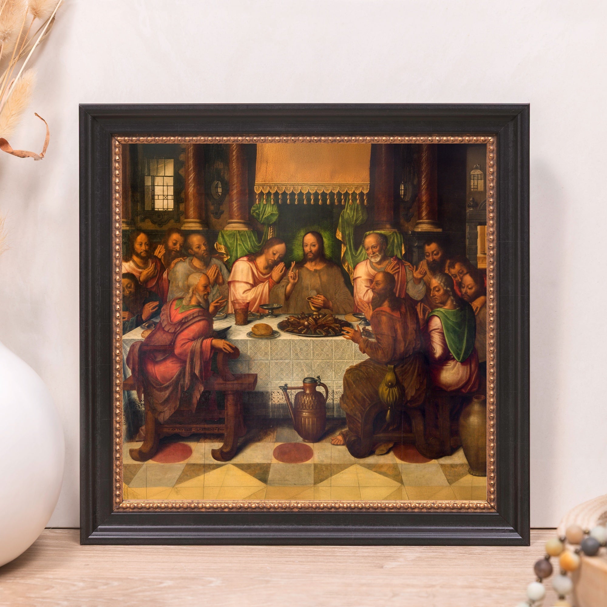 Framed painting of The Last Supper in Renaissance style with a black and gold wooden frame.