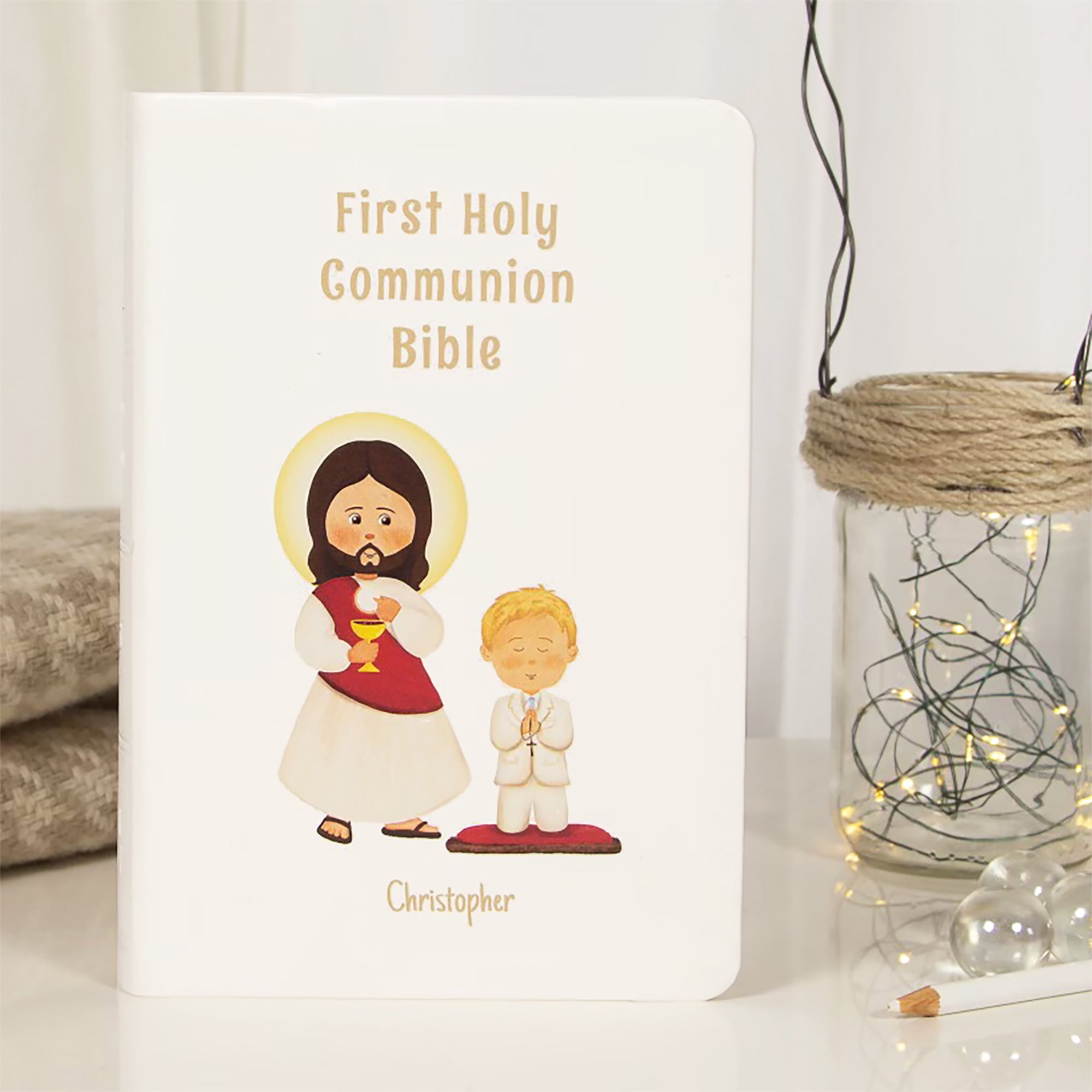 Personalized, illustrated white bible for a First Holy Communion celebration.