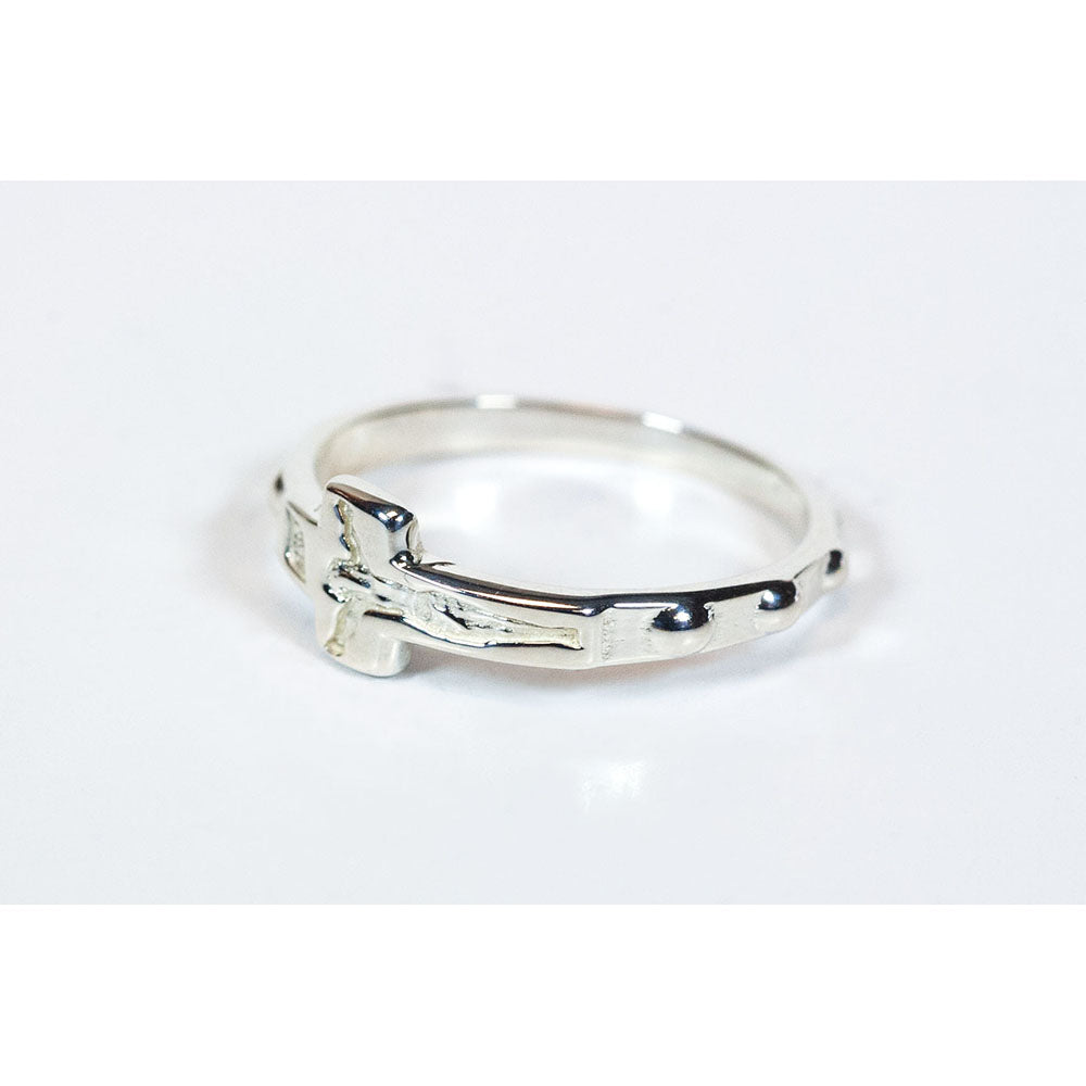 Silver-colored metal rosary ring featuring a prominent cross and bead-like accents around the band.