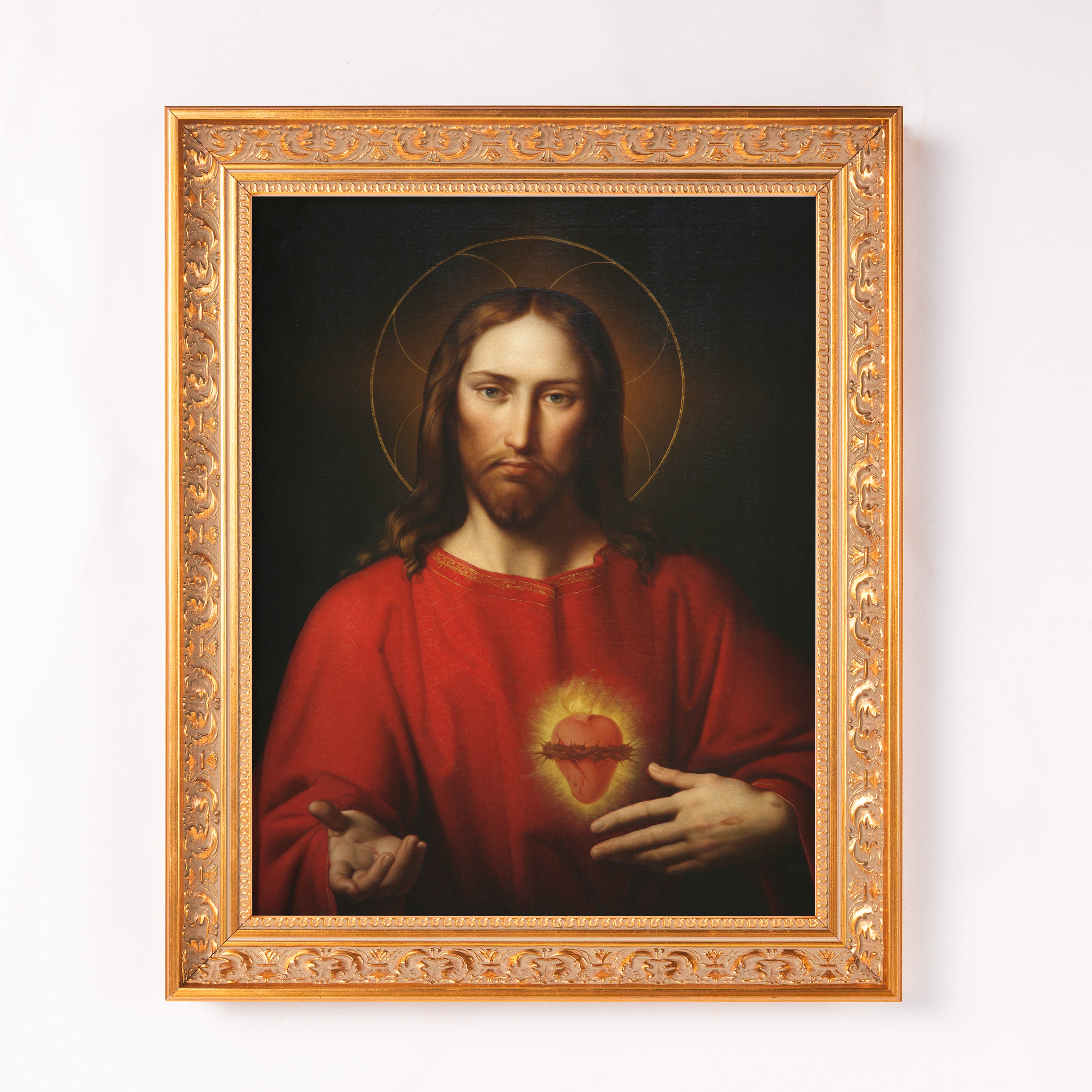 Framed painting of Jesus Christ with the Sacred Heart, set in an ornate gold frame.
