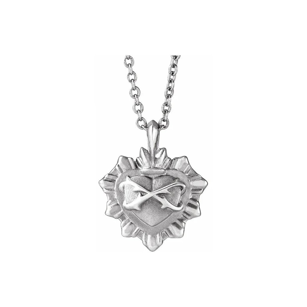 Silver necklace featuring heart pendant with crossed arrow design and textured frame.