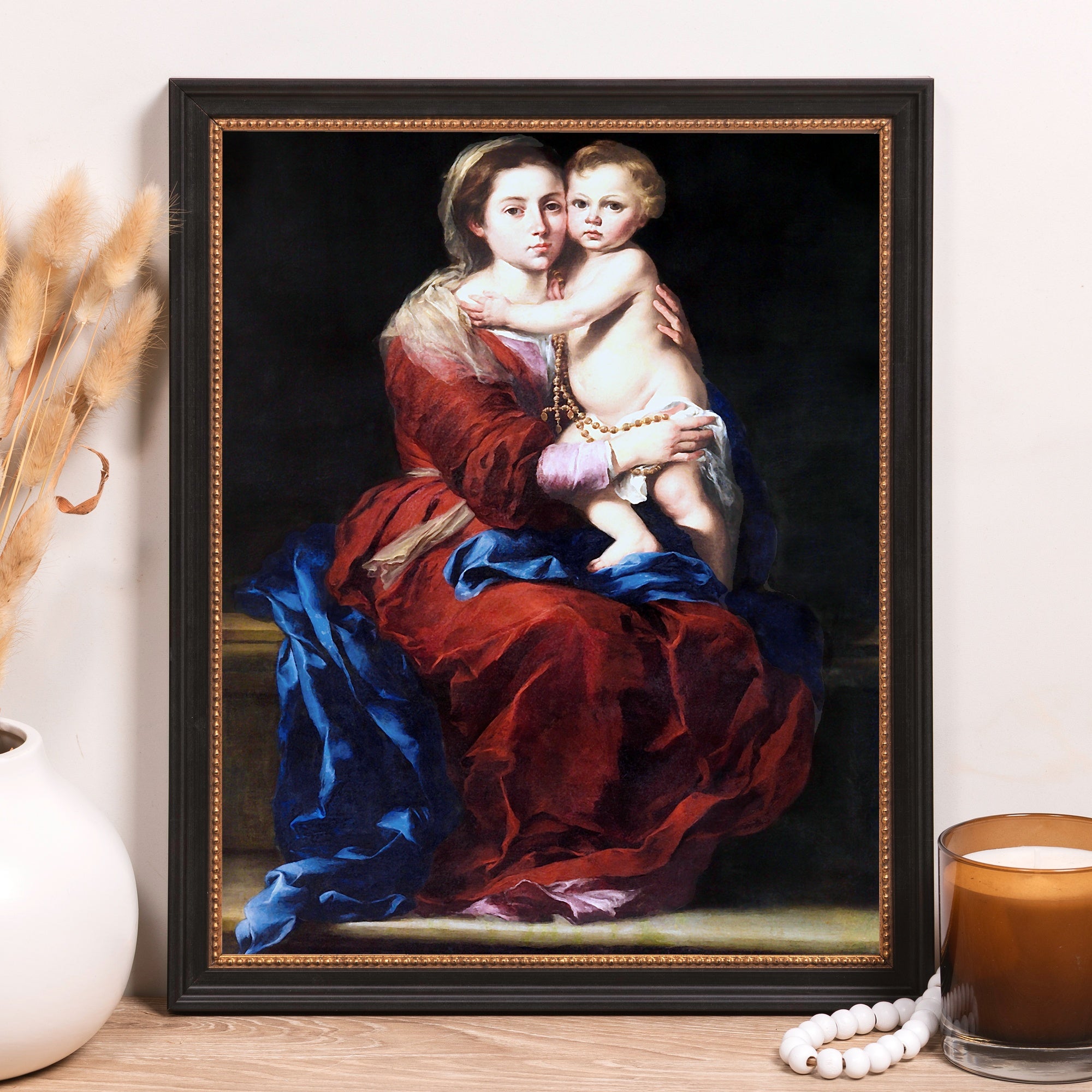 Framed canvas print features a portrait of mother and child in red and blue hues.