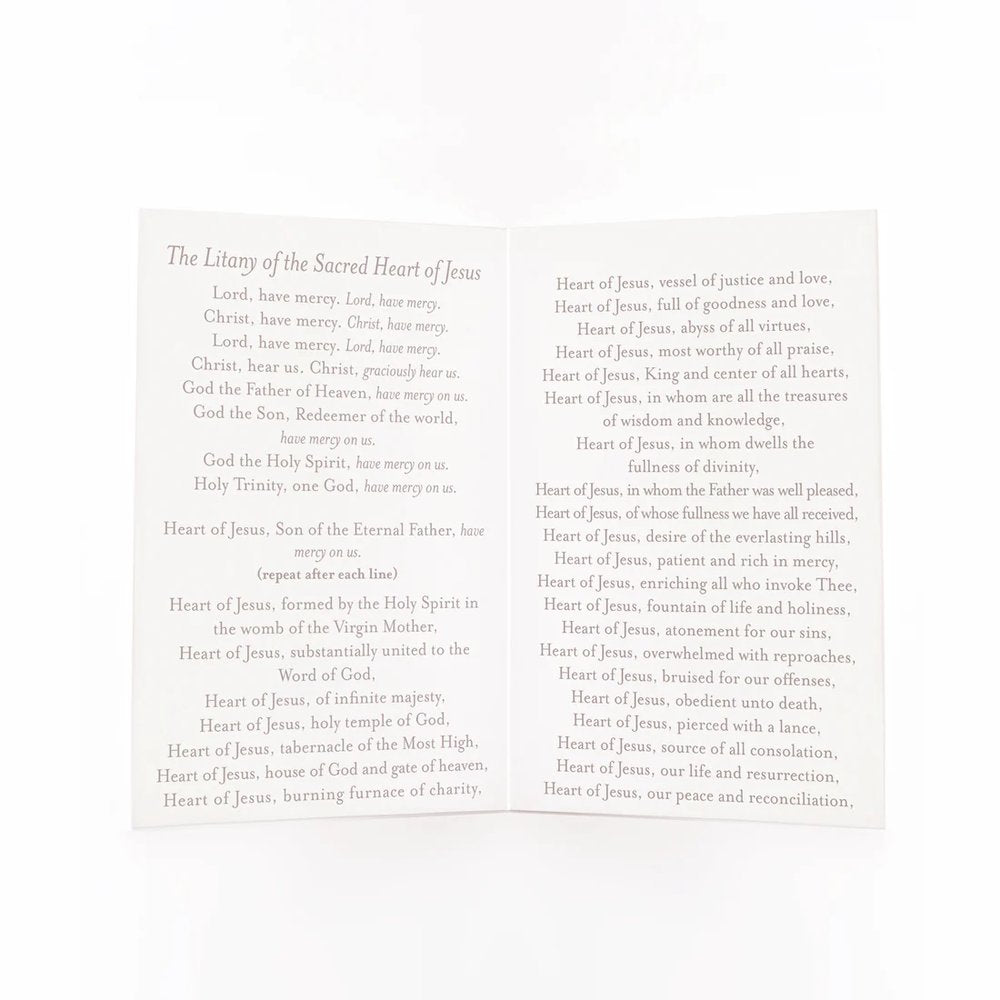 Open, White paper pamphlet with "The Litany of the Sacred Heart of Jesus" printed on both pages.