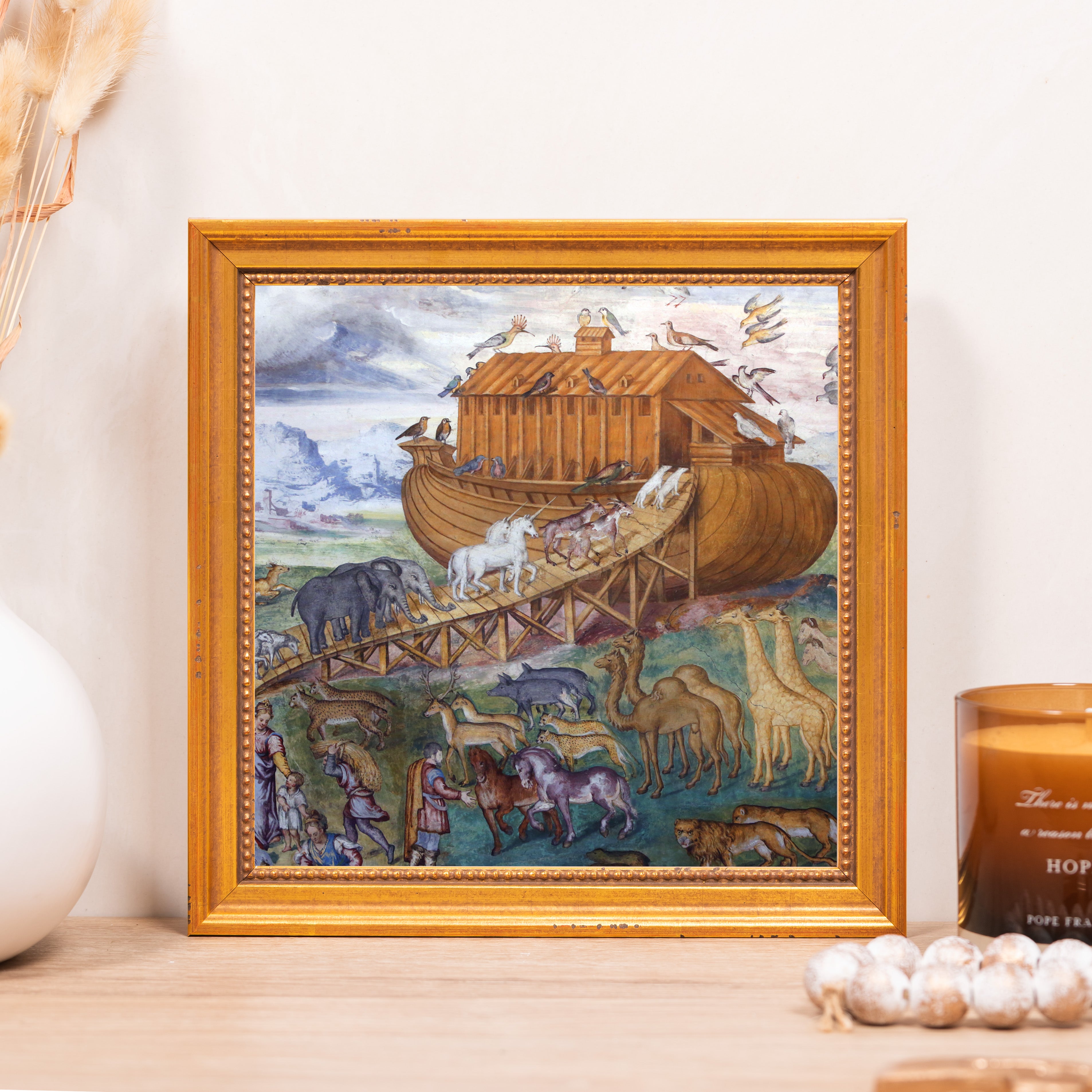 Framed Noah's Ark print with animals entering boat, ornate gold frame.