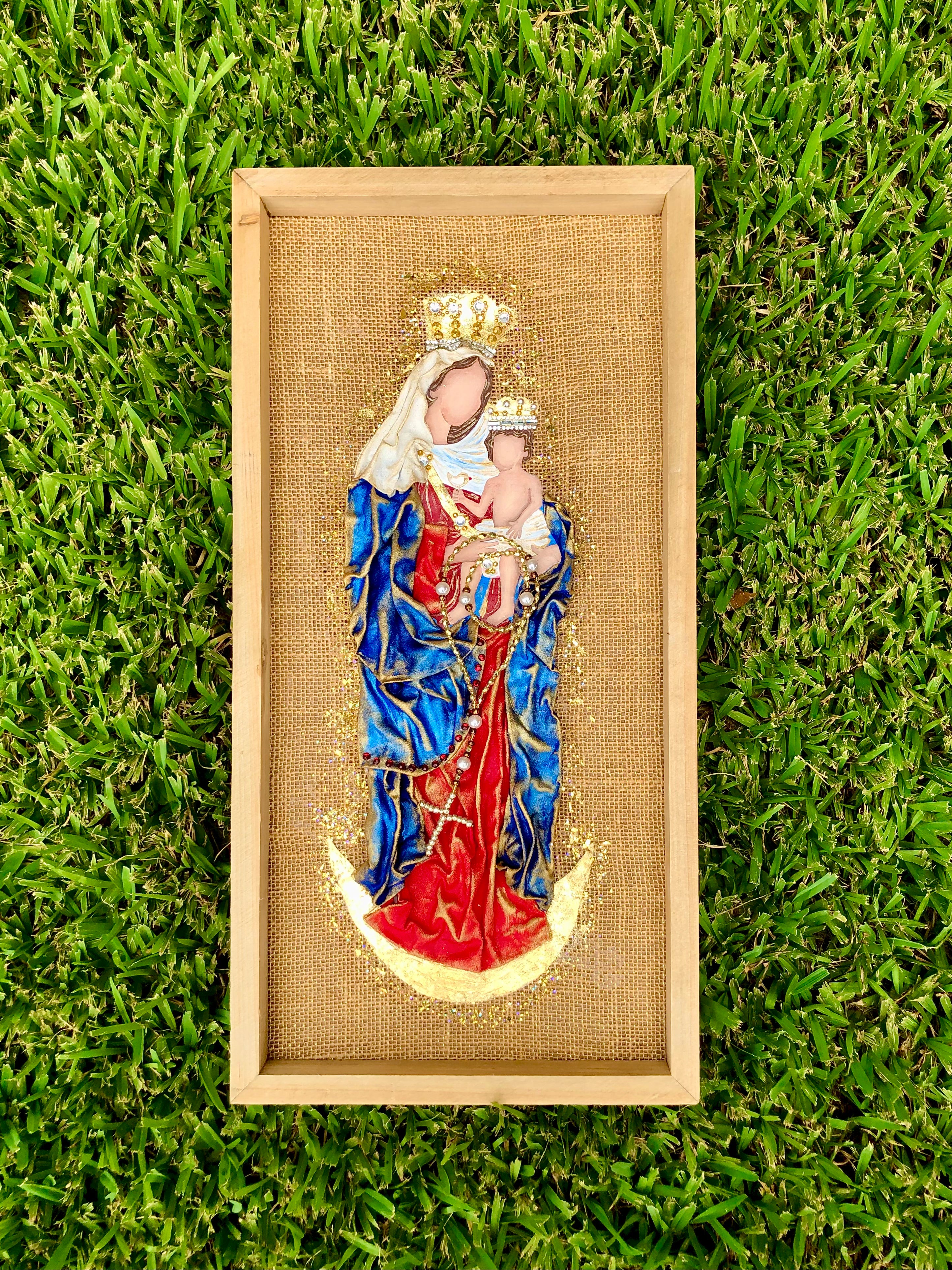 Framed Madonna and Child burlap wall art with blue, red, and gold accents.
