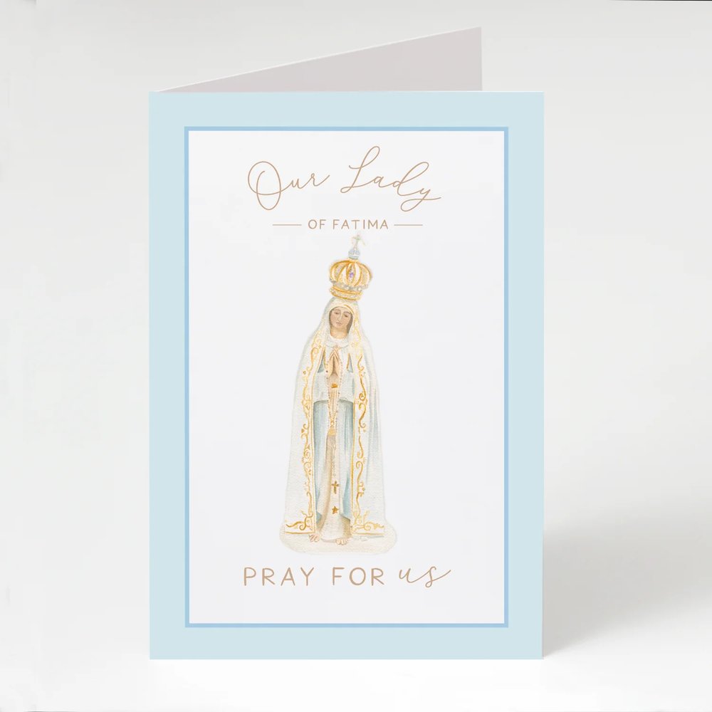 Greeting card of Our Lady of Fatima, light blue, with delicate gold lettering and accents.