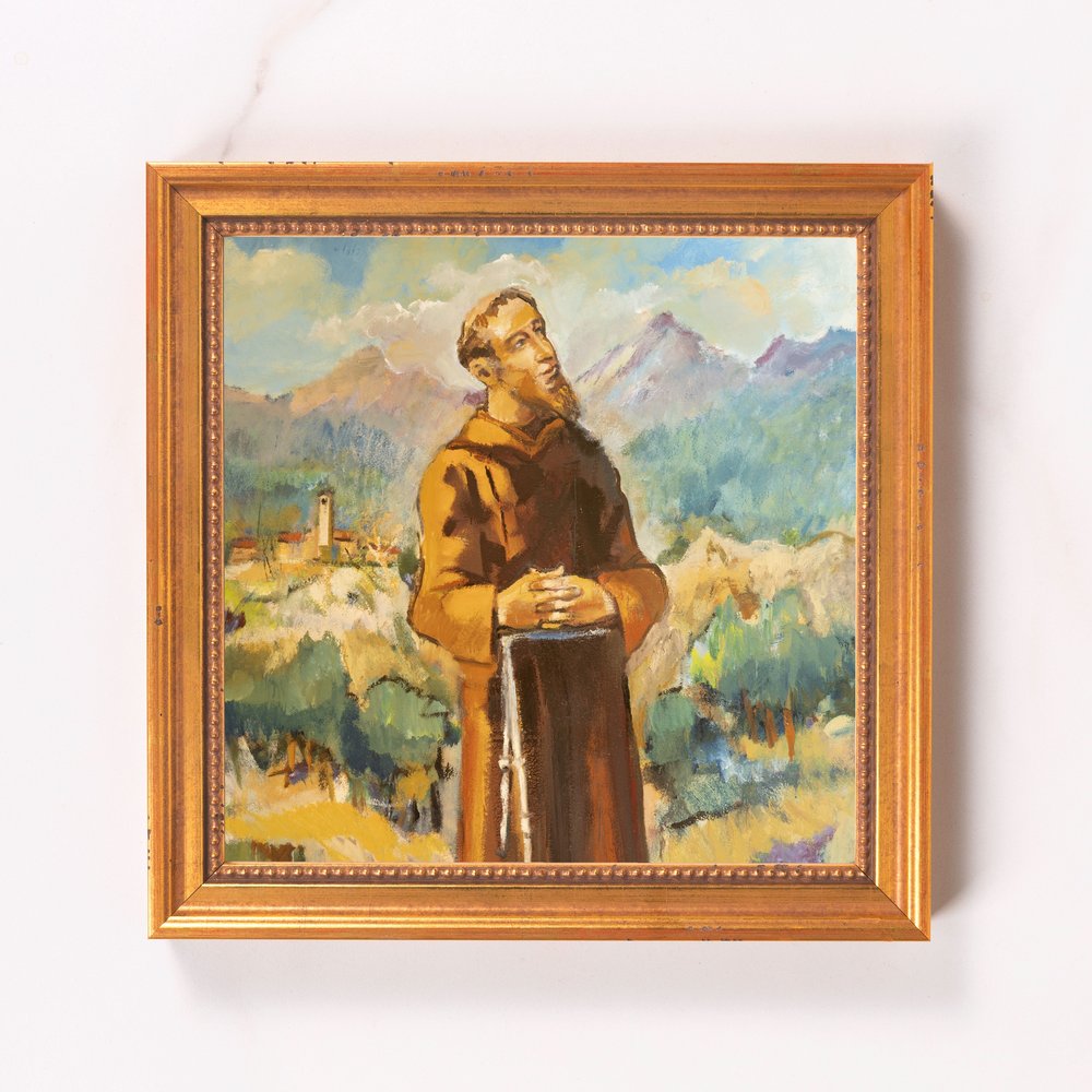 Framed oil painting depicting a monk in a brown robe against a landscape with mountains.