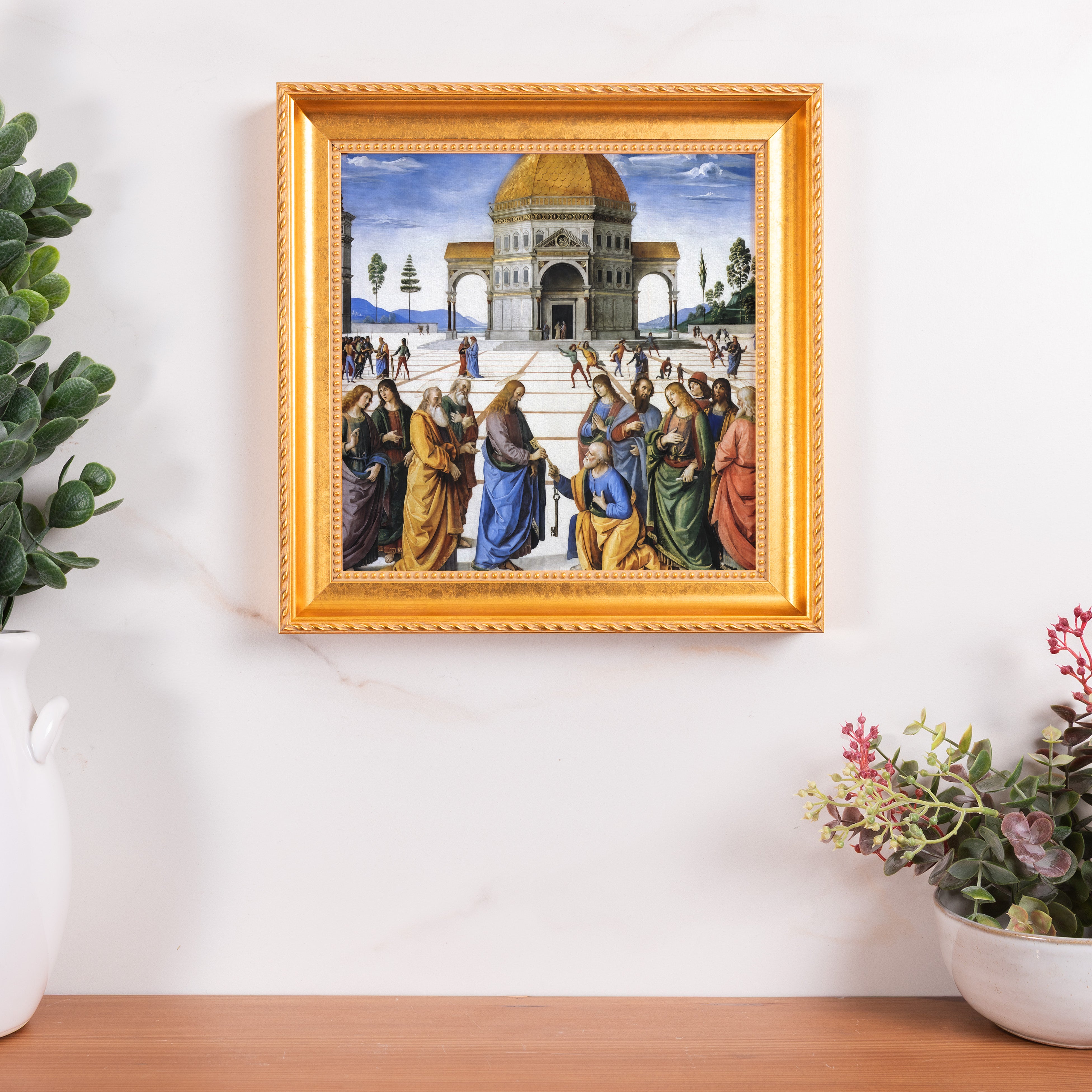 Framed Reproduction of “Christ Handing the Keys to St. Peter” painting with an ornate gold frame, hanging on a marble wall.