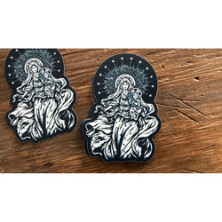 Black die-cut vinyl stickers depict Mary and baby Jesus with stars and a halo.