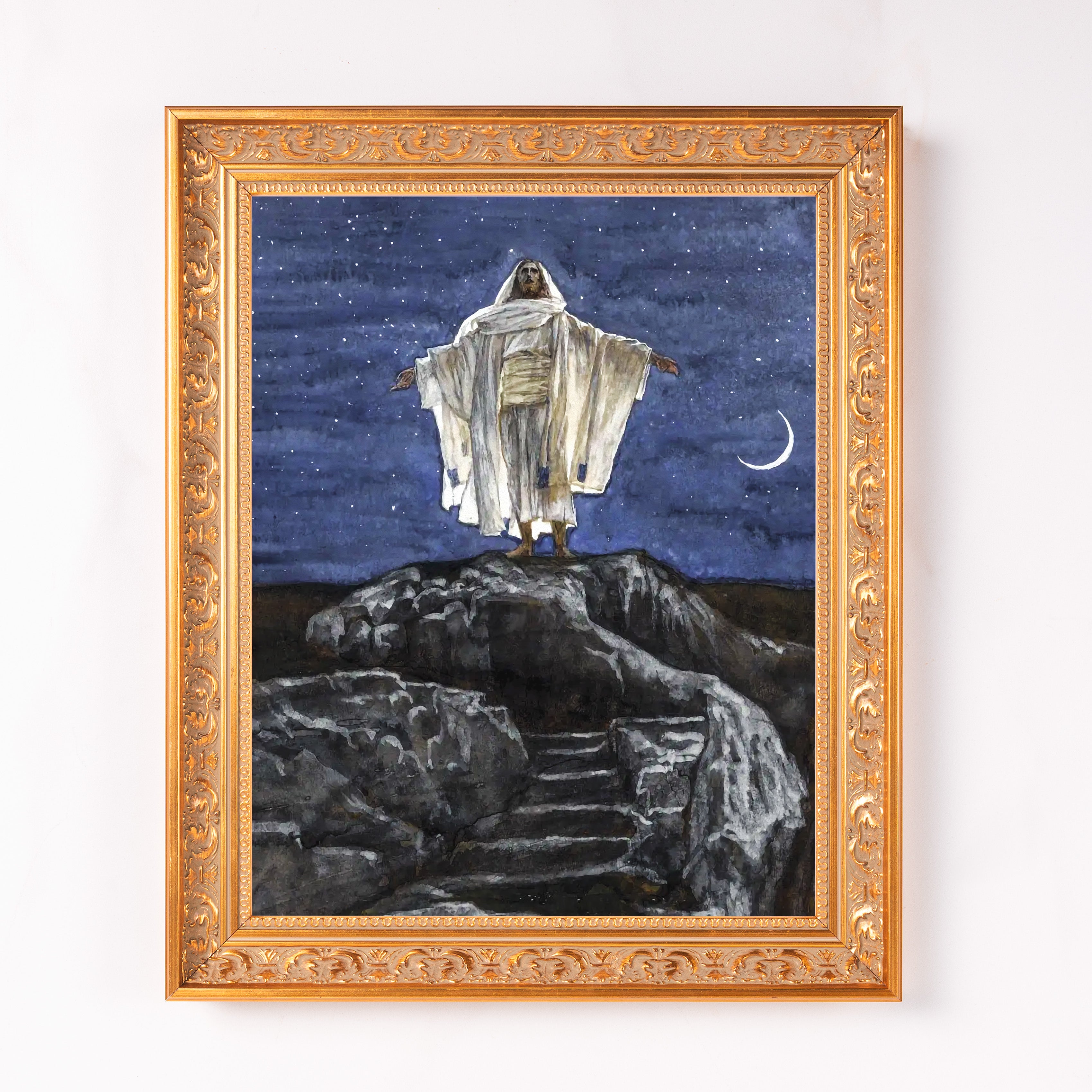 Framed art print with Jesus Christ in a white robe on a rocky hill against a starry sky.