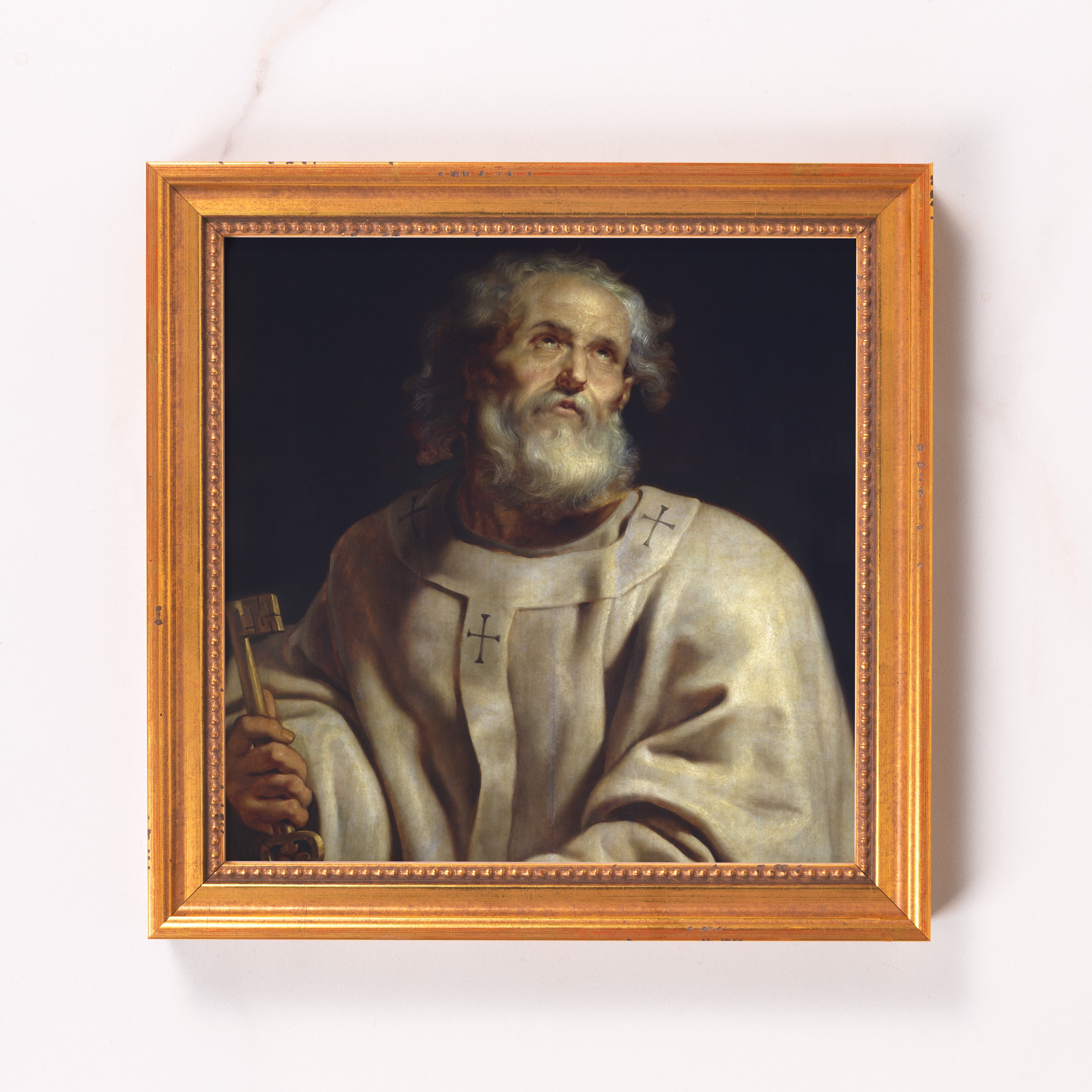 Framed painting of Saint Peter holding a key, in gold frame.