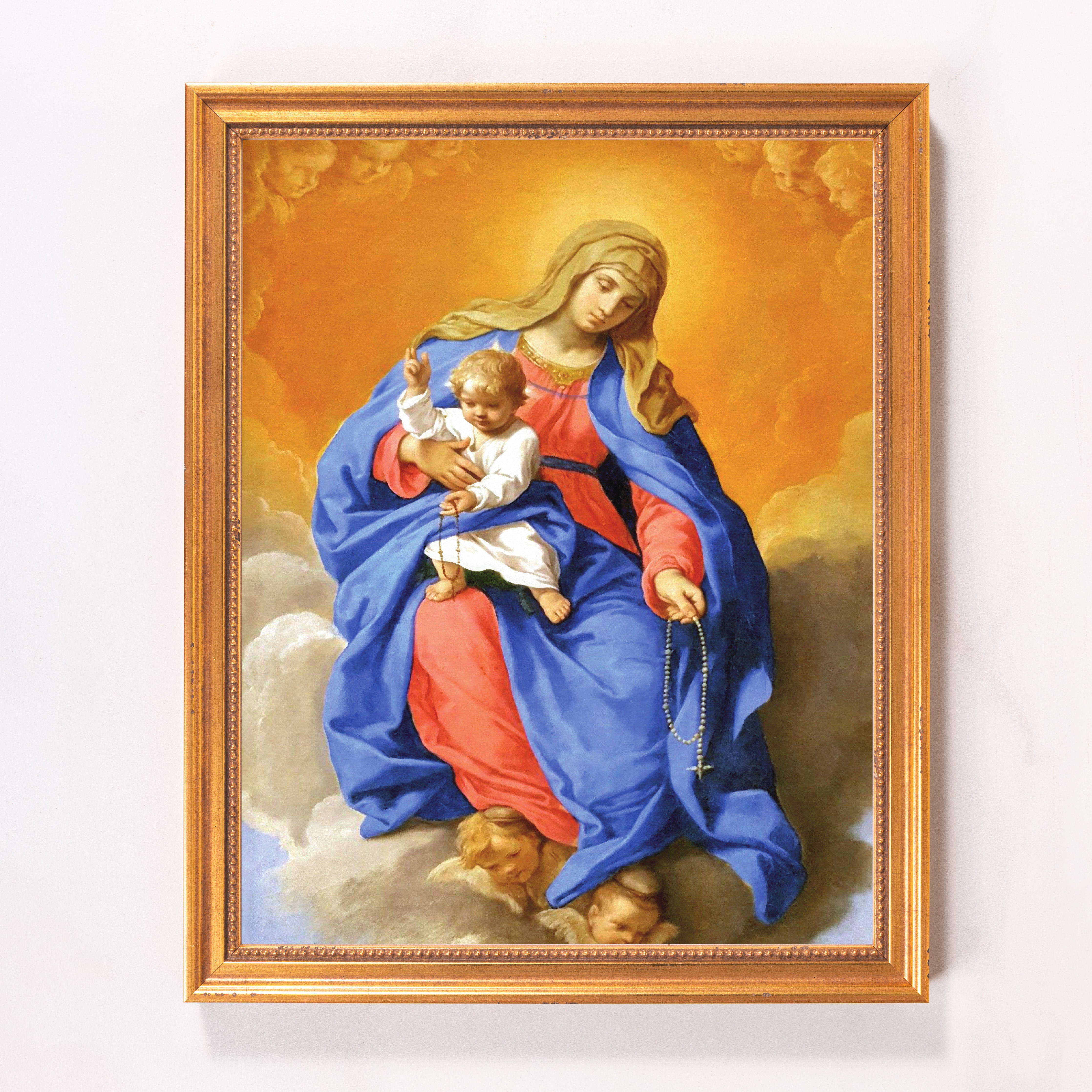 Framed religious art: Virgin Mary and child holding a rosary, with gold frame.