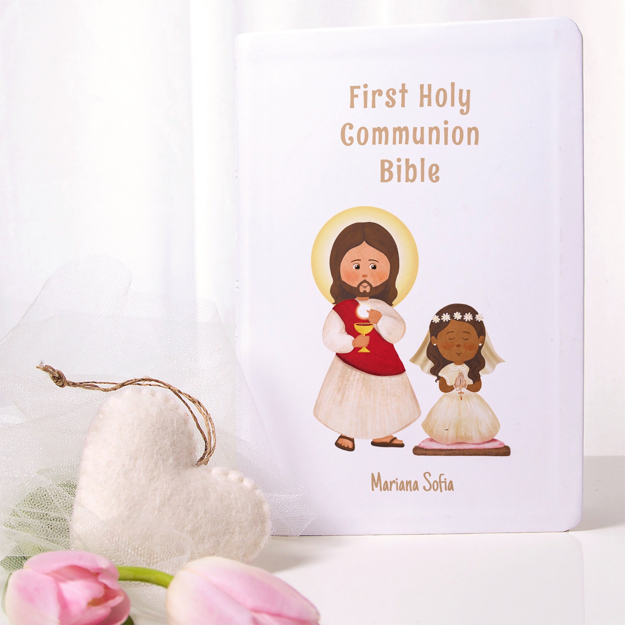 First Communion Bible, white hardback with illustrations of Jesus and a girl in a white dress.