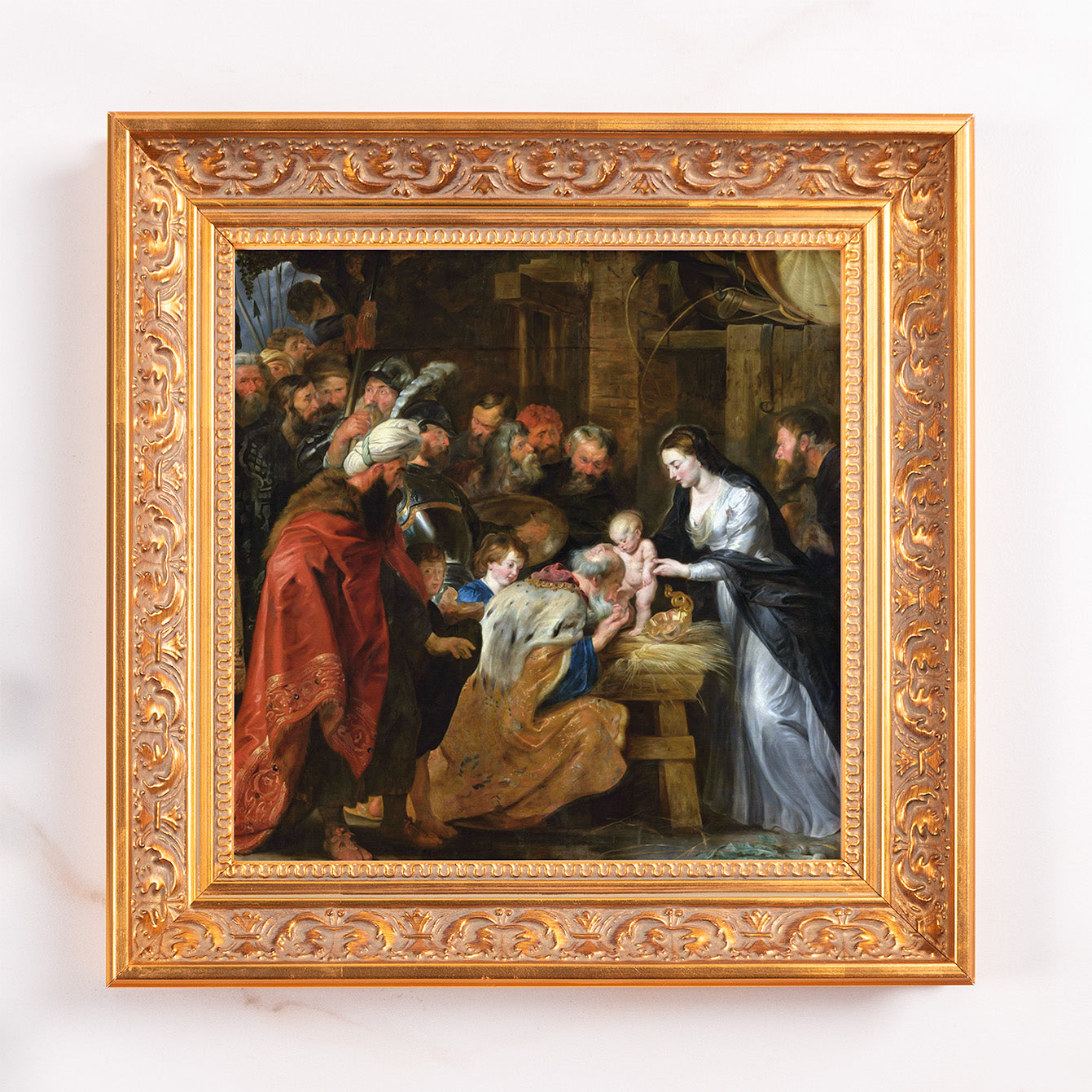Framed painting depicts the Adoration of the Magi in warm tones with a gold ornate frame.